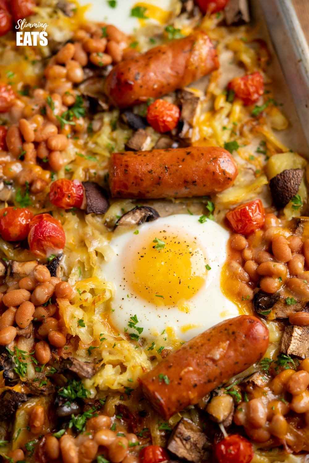 The Ultimate All Day Breakfast Tray Bake - so delicious, you will enjoy this easy simple recipe any time of day. Gluten Free, Vegetarian, Slimming Eats and Weight Watchers friendly All Day Breakfast Tray Bake on a parchment lined baking tray