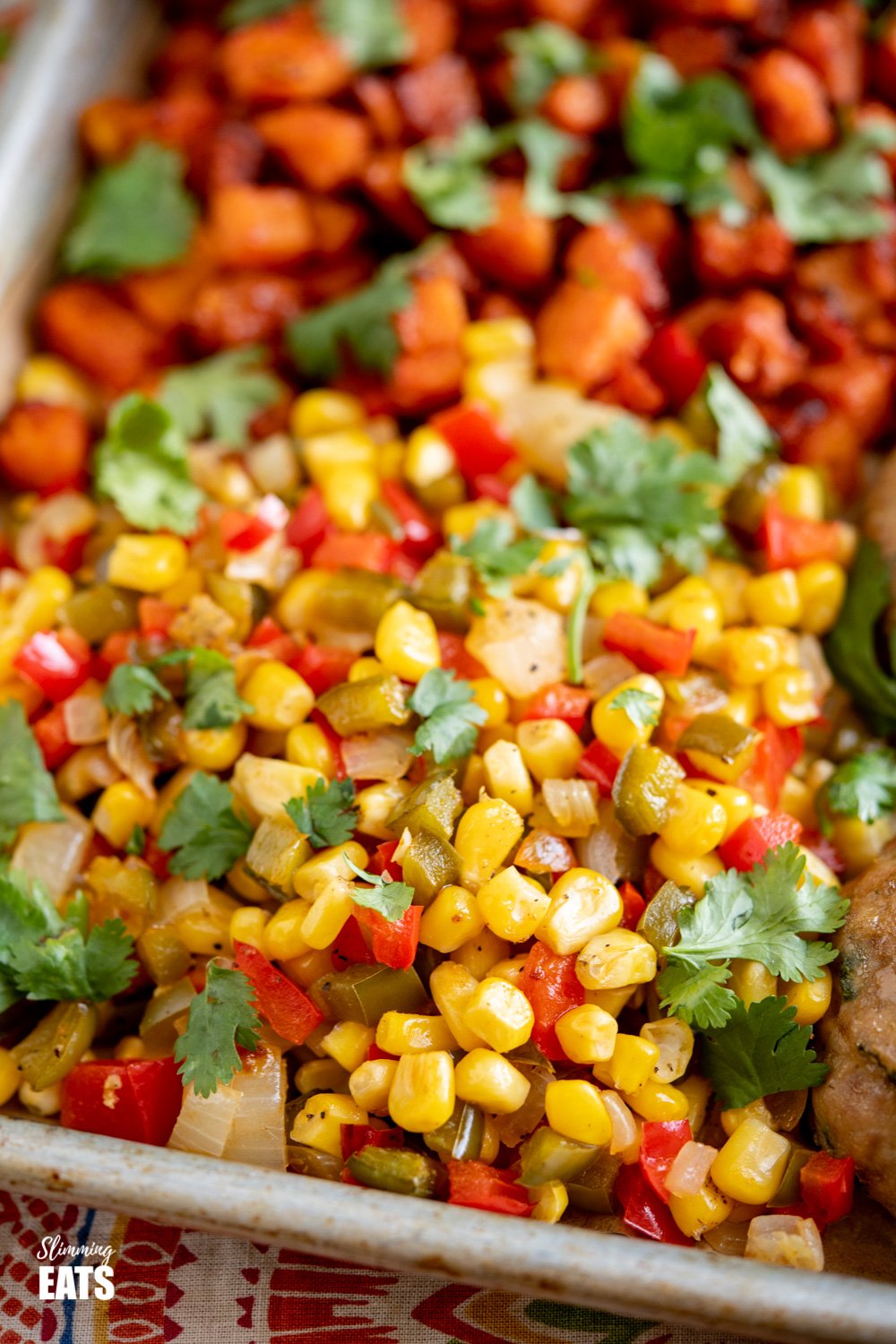 close up of roasted corn, peppers and onion on baking tray