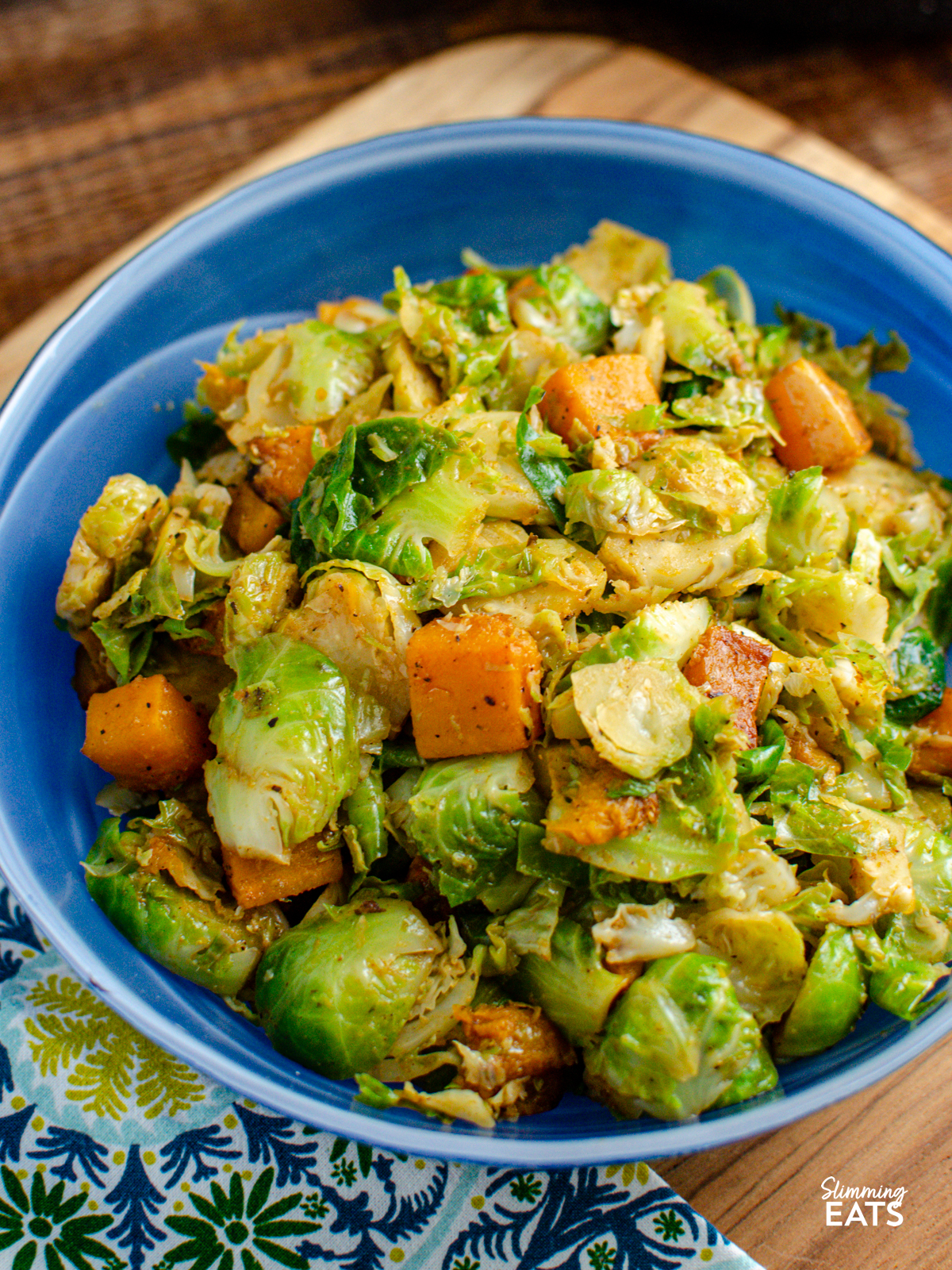 Sautéed Brussels Sprouts with Roasted Butternut Squash in a blue glass bowl