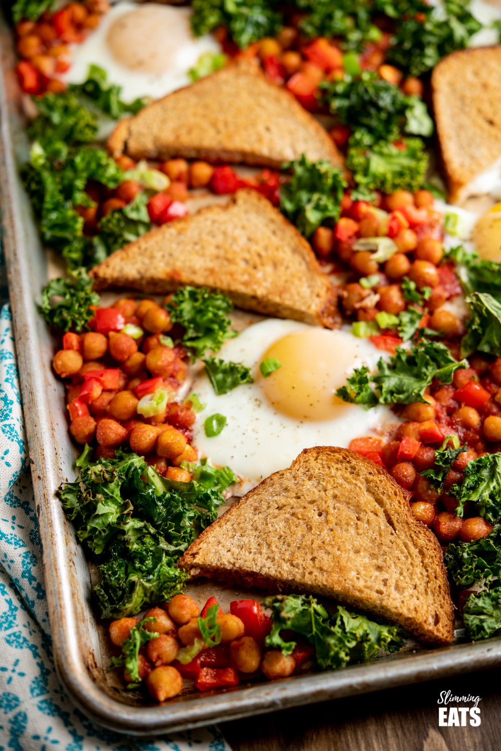 chickpea, egg and kale with crispy whole wheat toast on baking tray