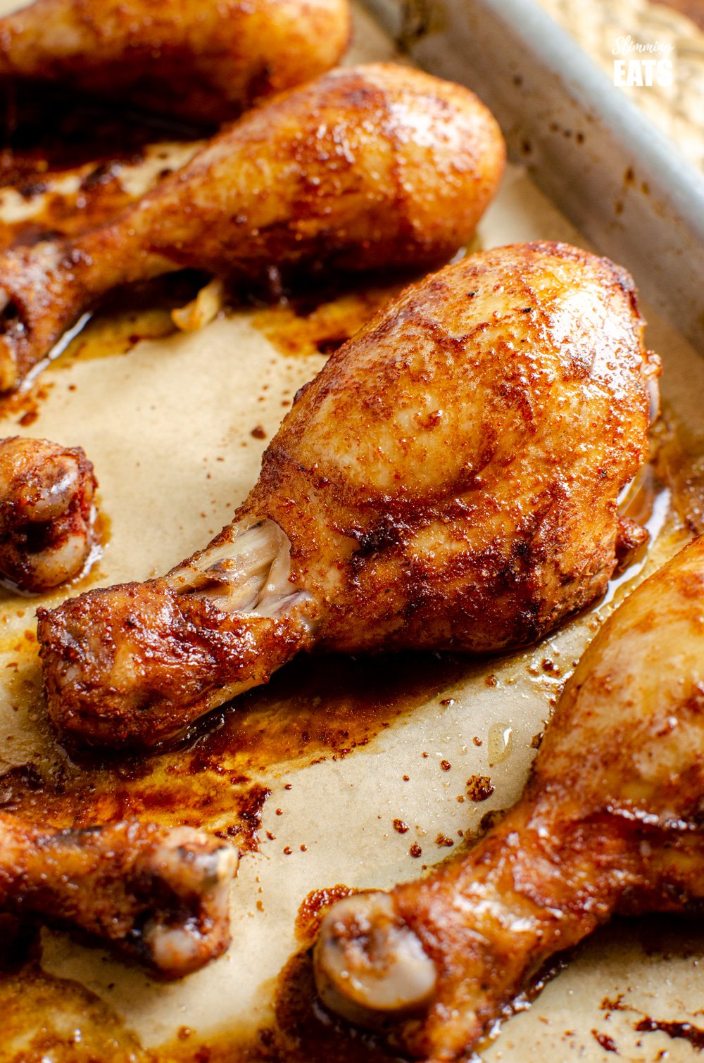 baked paprika chicken drumsticks on a baking tray