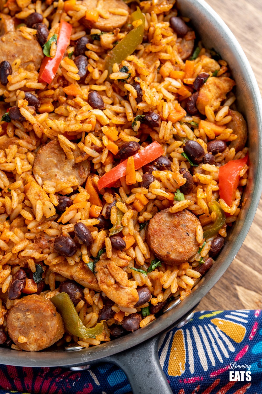 One Pot Cuban Style Rice (with Chicken and Sausage) - this delicious one-pot recipe with spicy seasonings, fresh vegetables and black beans is a perfect meal for any night of the week. Gluten Free, Dairy Free, Slimming Eats and Weight Watchers friendly close up of One Pot Cuban Style Rice in frying pan