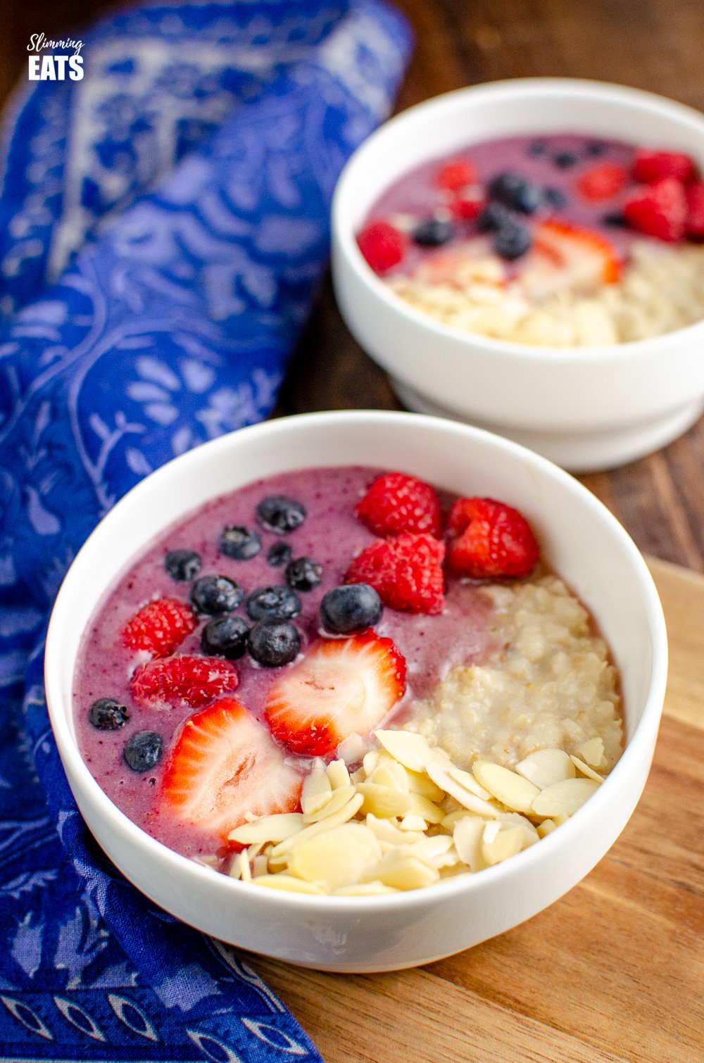 2 white Oatmeal Smoothie Bowl with pattern blue napkin to the left