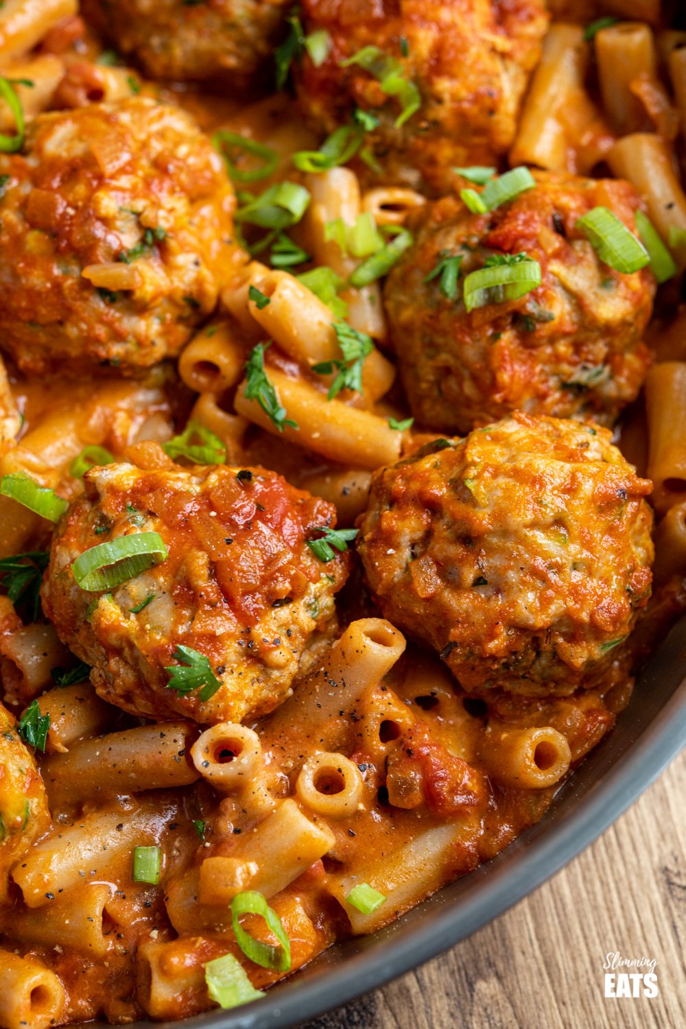 close up of creamy cajun chicken meatball pasta in frying pan