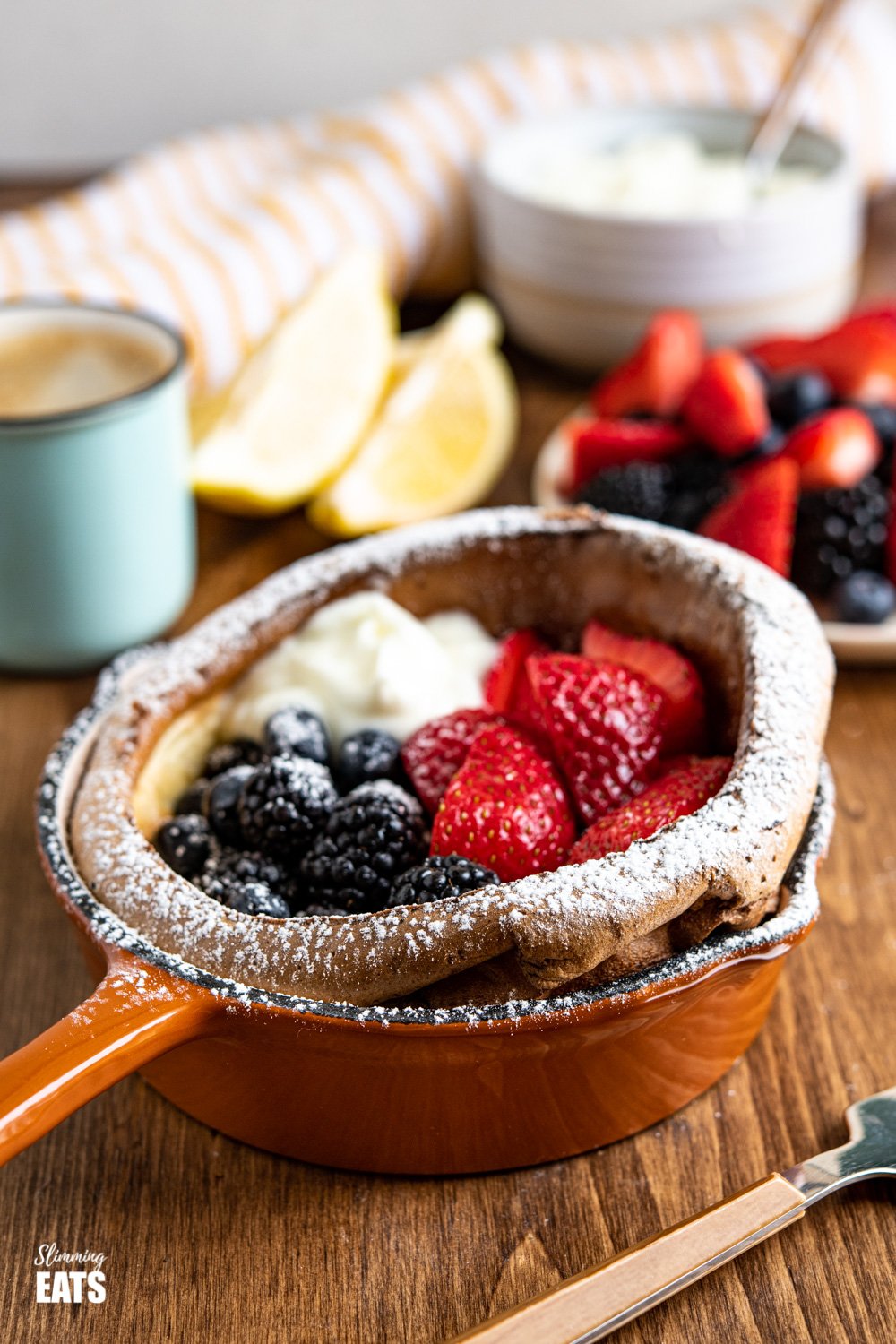 Healthier Dutch Baby with Berries and Yoghurt in cast iron skillet