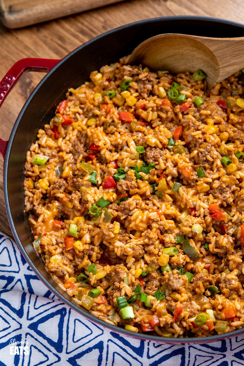  close up of Taco Beef Rice in red Staub cast iron skillet with wooden spoon