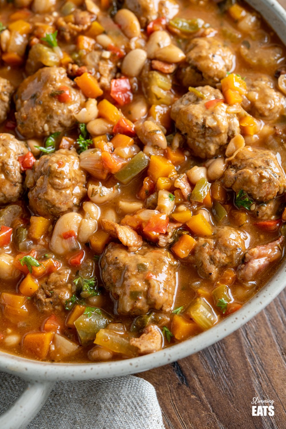 close up of chicken meatball cassoulet in grey brown dish
