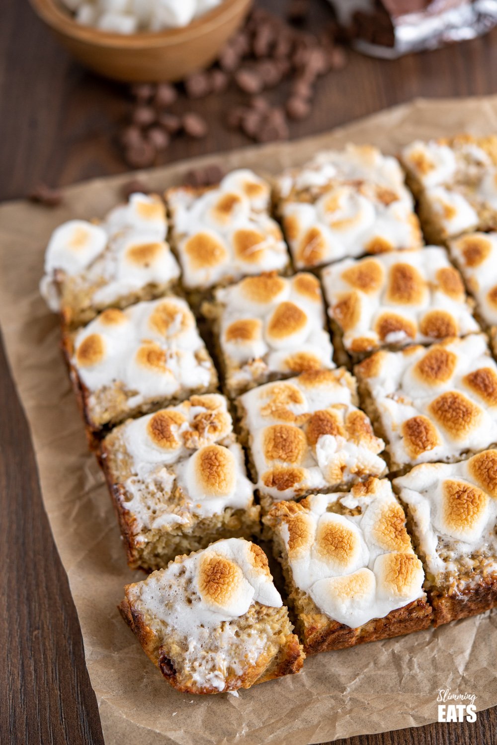 sliced toasted marshmallow oat bars on a sheet of parchment paper