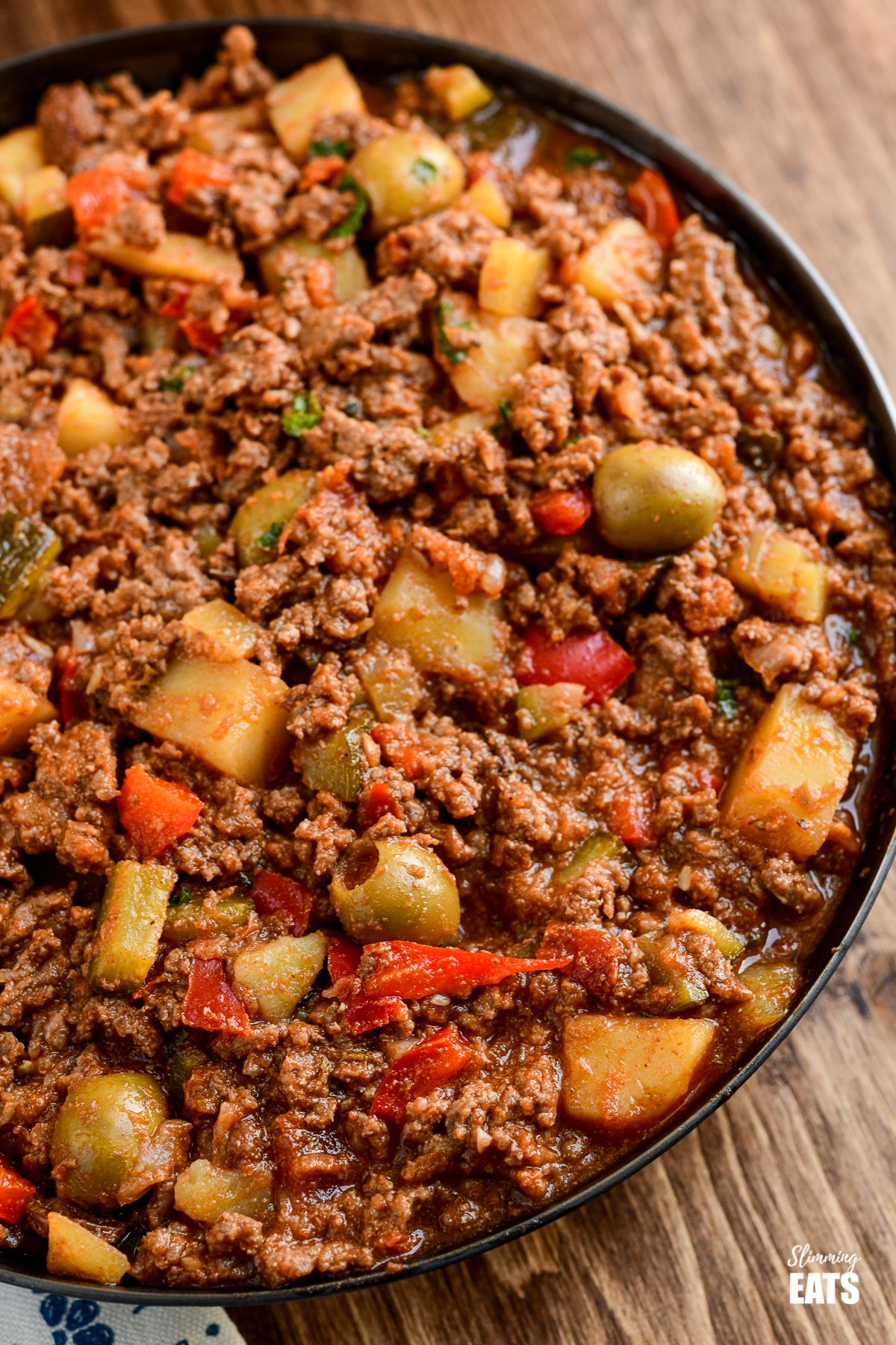 Cuban Beef Picadillo - a delicious hearty ground beef Cuban inspired recipe with flavoursome spices, potatoes, vegetables, olives and sultanas. #Cuban #picadillo #olives #beef #slimmingeats #weightwatchers #glutenfree #dairyfree Cuban Beef Picadillo close up in frying pan