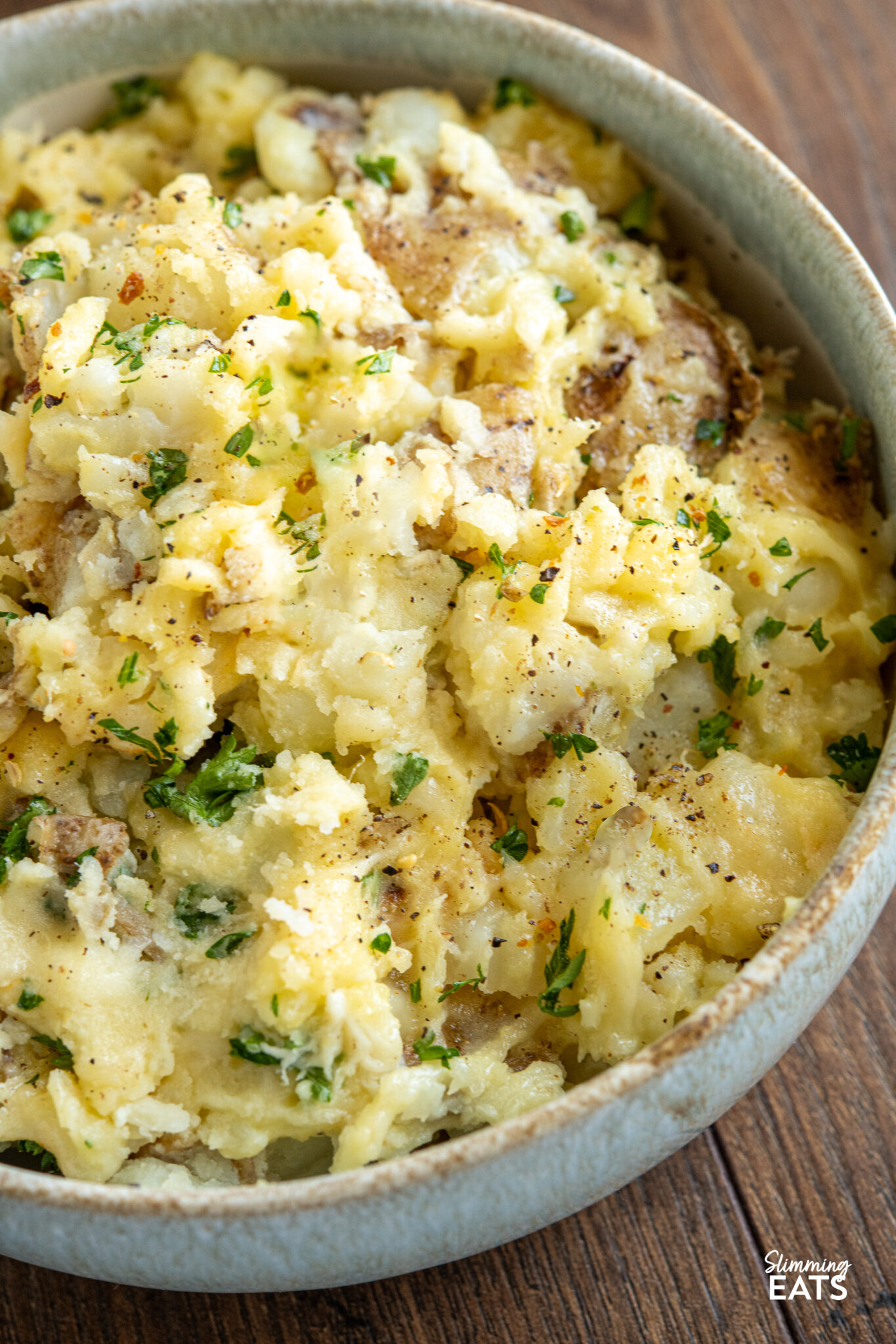 Rustic Parmesan Garlic Mashed Potatoes served in a pale blue and white bowl