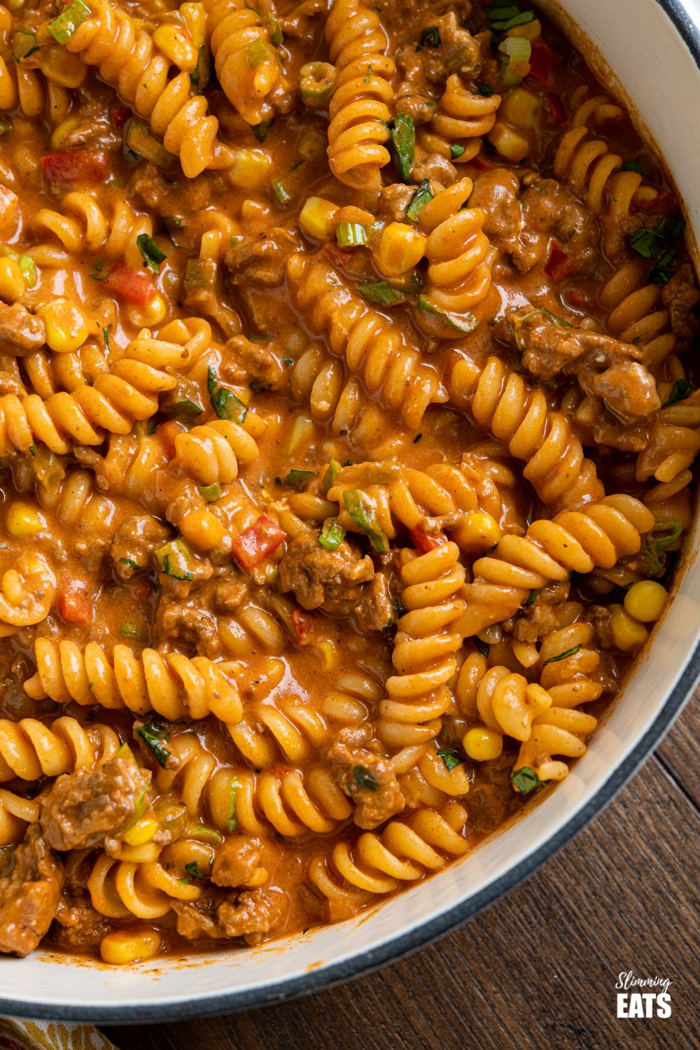 One Pot Taco Beef Pasta - an easy yummy recipe that is cooked all in one pan. Cheesy spicy taco flavoured deliciousness!! #slimmingeats #weightwatchers #onepot #beef #pasta #taco close up of One Pot Taco Beef Pasta in skillet