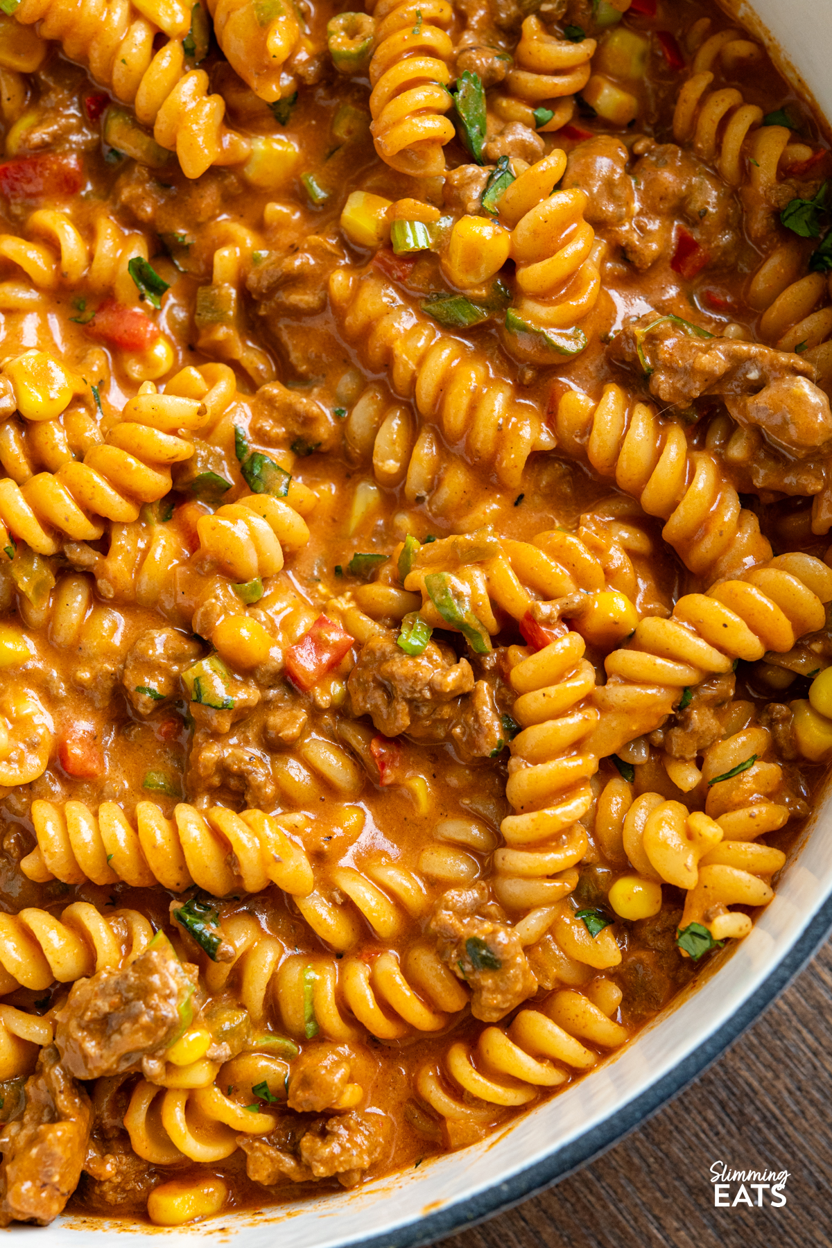 One Pot Taco Beef Pasta - an easy yummy recipe that is cooked all in one pan. Cheesy spicy taco flavoured deliciousness!! #slimmingeats #weightwatchers #onepot #beef #pasta #taco close up of One Pot Taco Beef Pasta in skillet