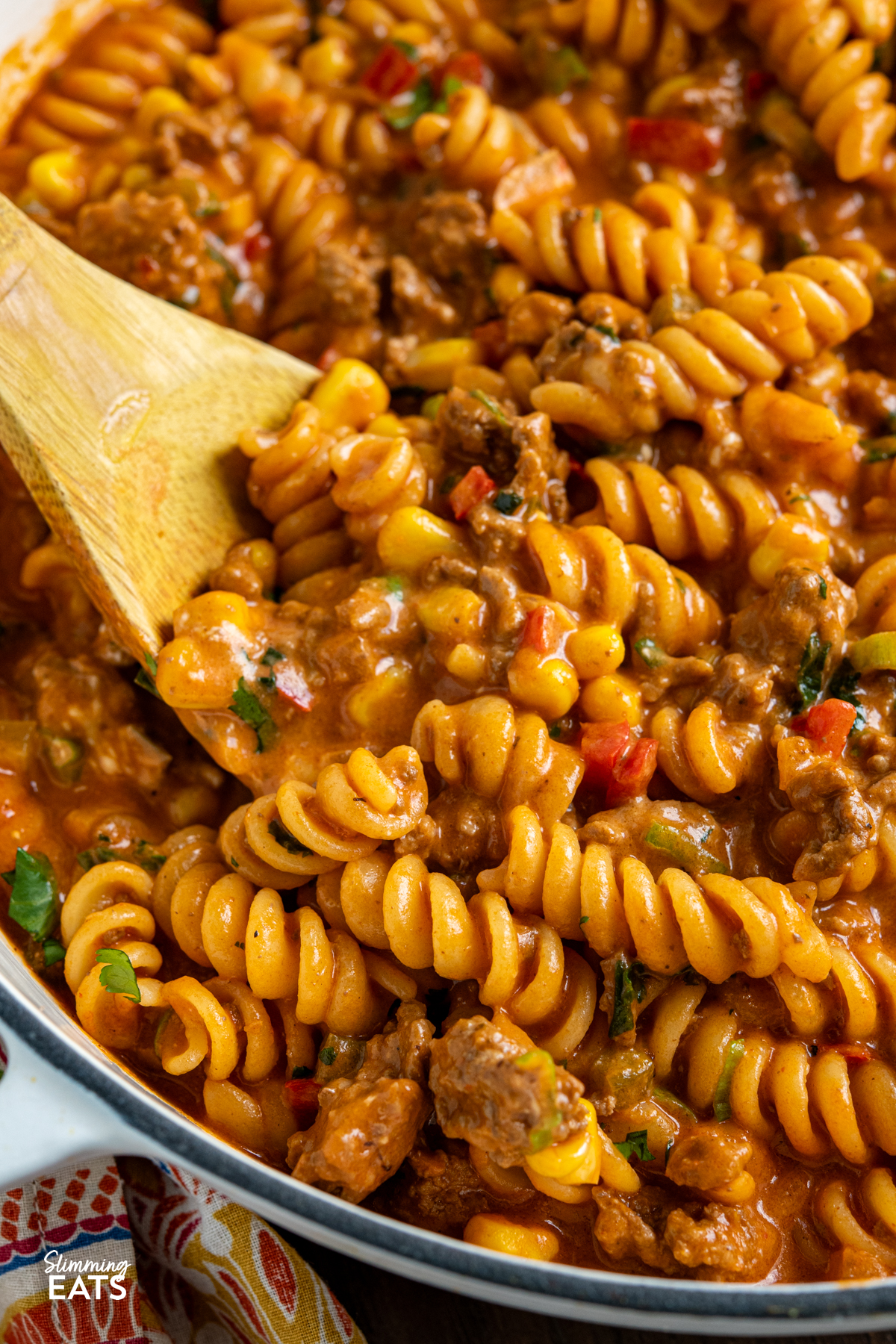 One Pot Taco Beef Pasta - an easy yummy recipe that is cooked all in one pan. Cheesy spicy taco flavoured deliciousness!! #slimmingeats #weightwatchers #onepot #beef #pasta #taco close up of One Pot Taco Beef Pasta in skillet