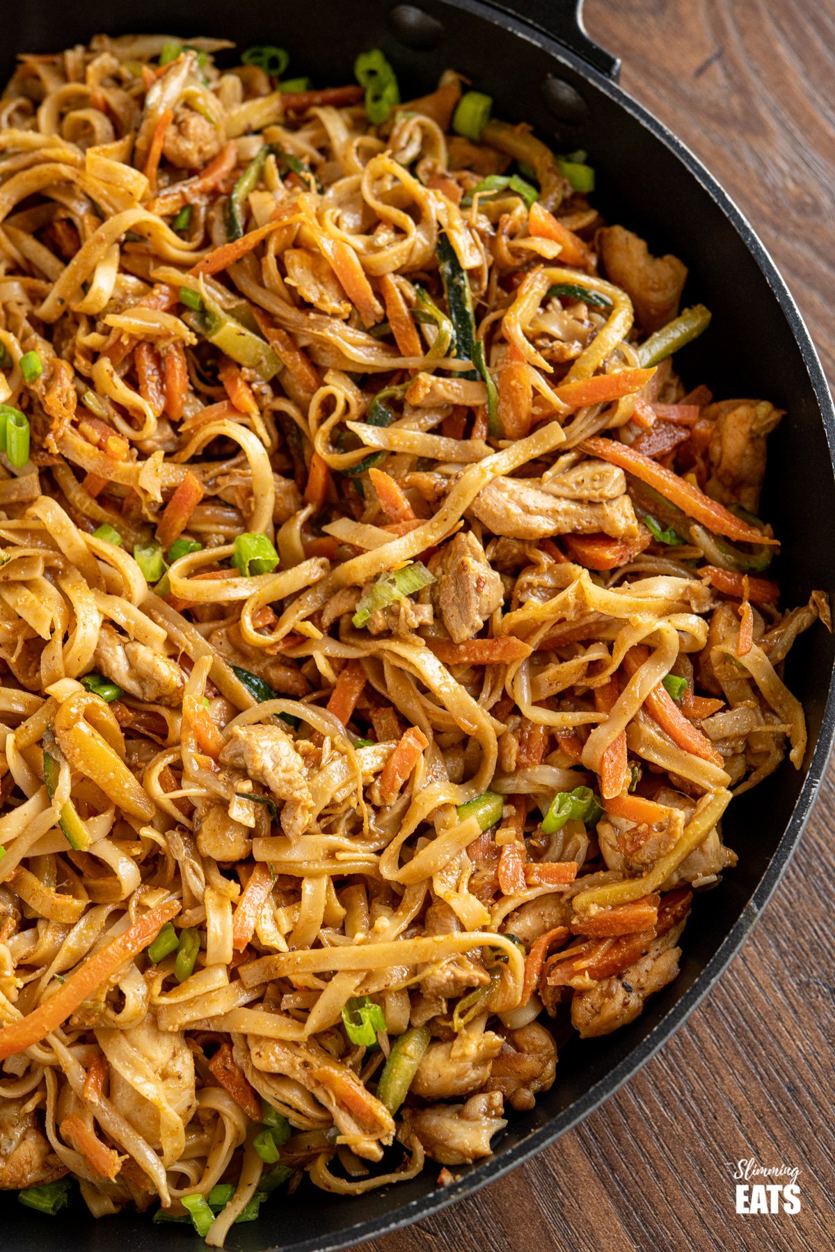 close up of Easy Peanut Chicken Noodles in black frying pan