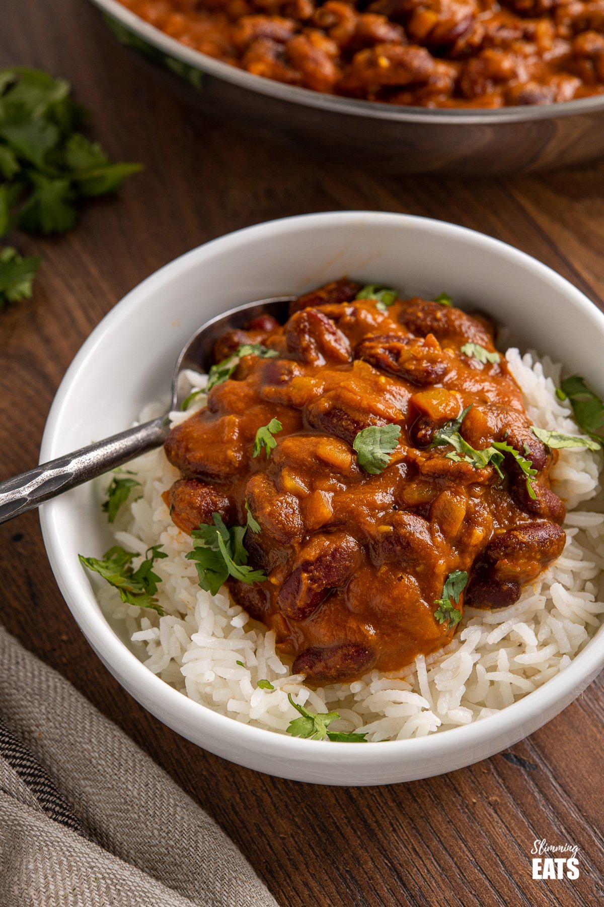 Kidney Bean Curry (Rajma) from www.slimmingeats.com - a delicious vegetarian curry made with Red Kidney Beans, onions, tomato (passata) and a blend of spices. #bean #curry #slimmingeats #weightwatchers #vegetarian #Indian kidney bean curry (rajma) over basmati rice in white bowl
