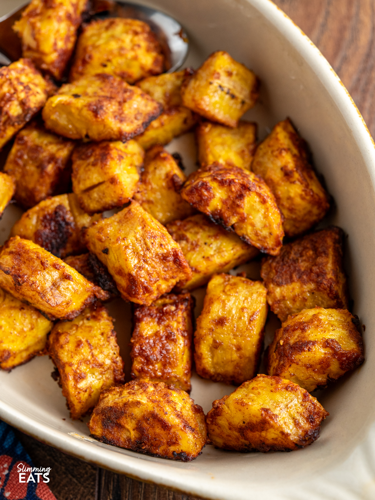cooked seasoned sweet plantain in a oval brown and beige ceramic dish
