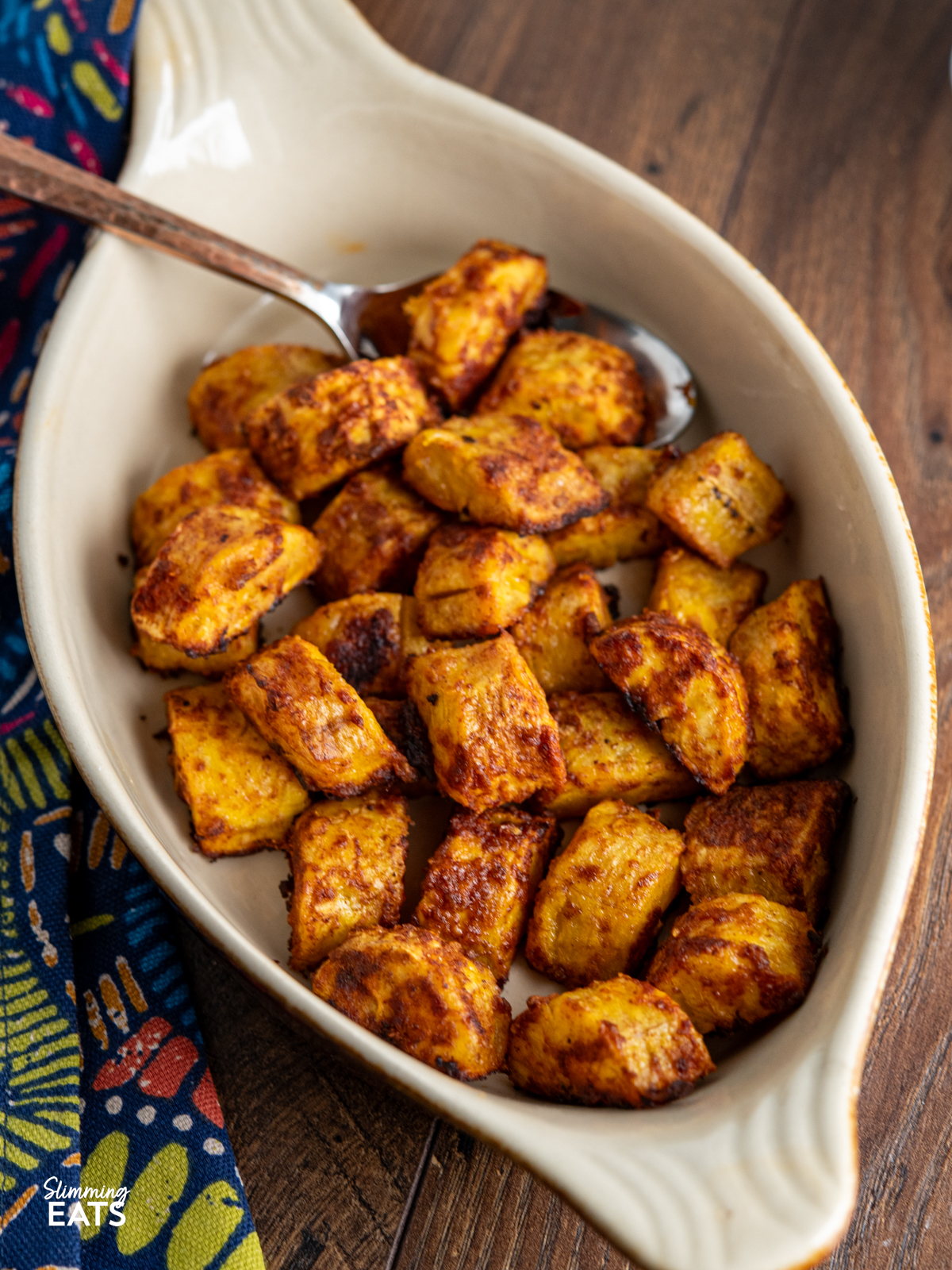 cooked seasoned sweet plantain in a oval brown and beige ceramic dish