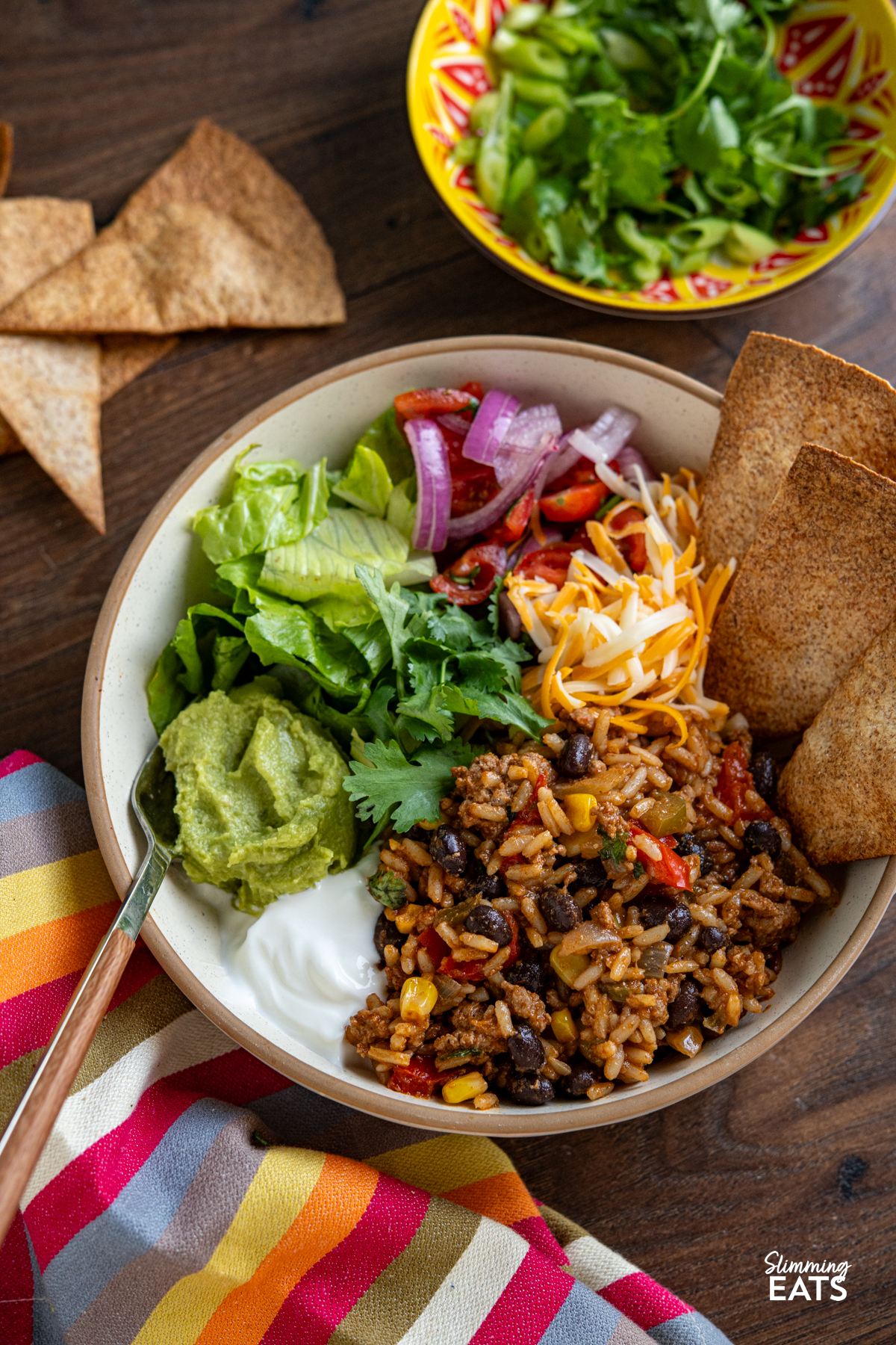 Turkey Burrito Rice bowl with lettuce colby jack cheese, guacamole, soured cream and crispy oven baked whole meal tortillas
