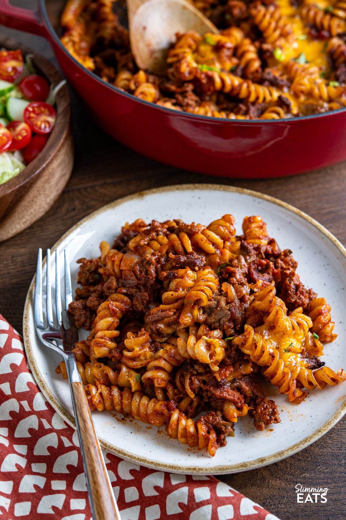 This BBQ Bacon Cheeseburger Pasta Bake is a hearty, flavour-packed family dinner with all the best cheeseburger flavours combined in one cheesy, comforting pasta dish. serving of BBQ Bacon Cheeseburger Pasta Bake on white plate with beige rim