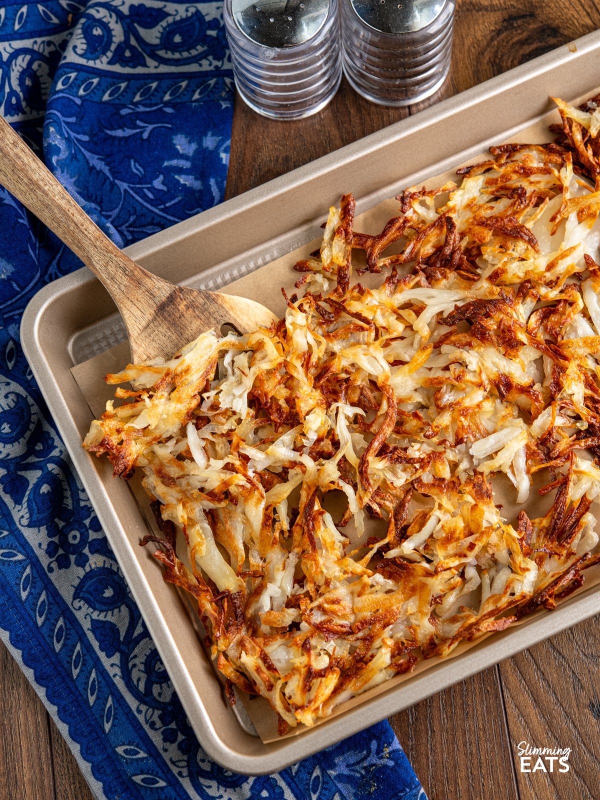 sheet pan hash browns cooked on parchment lined tray
