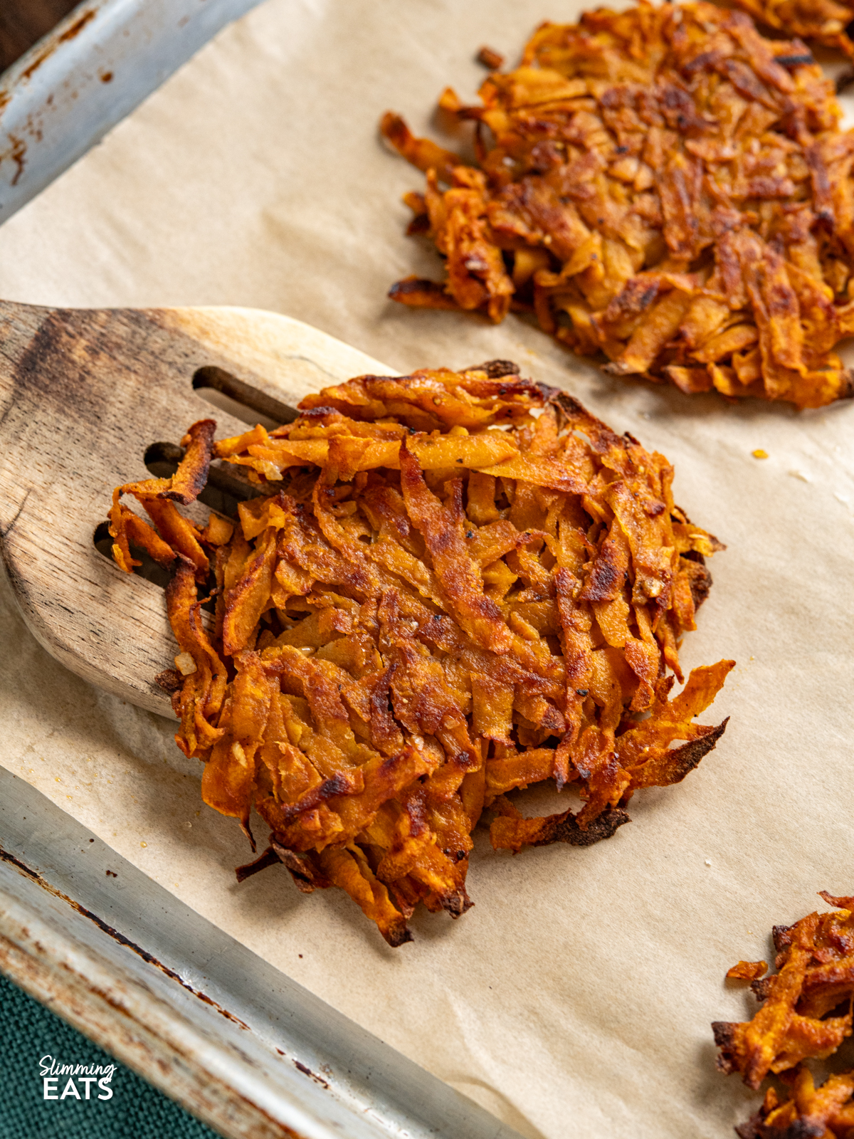 sweet potato hash browns all cooked on a parchment lined tray