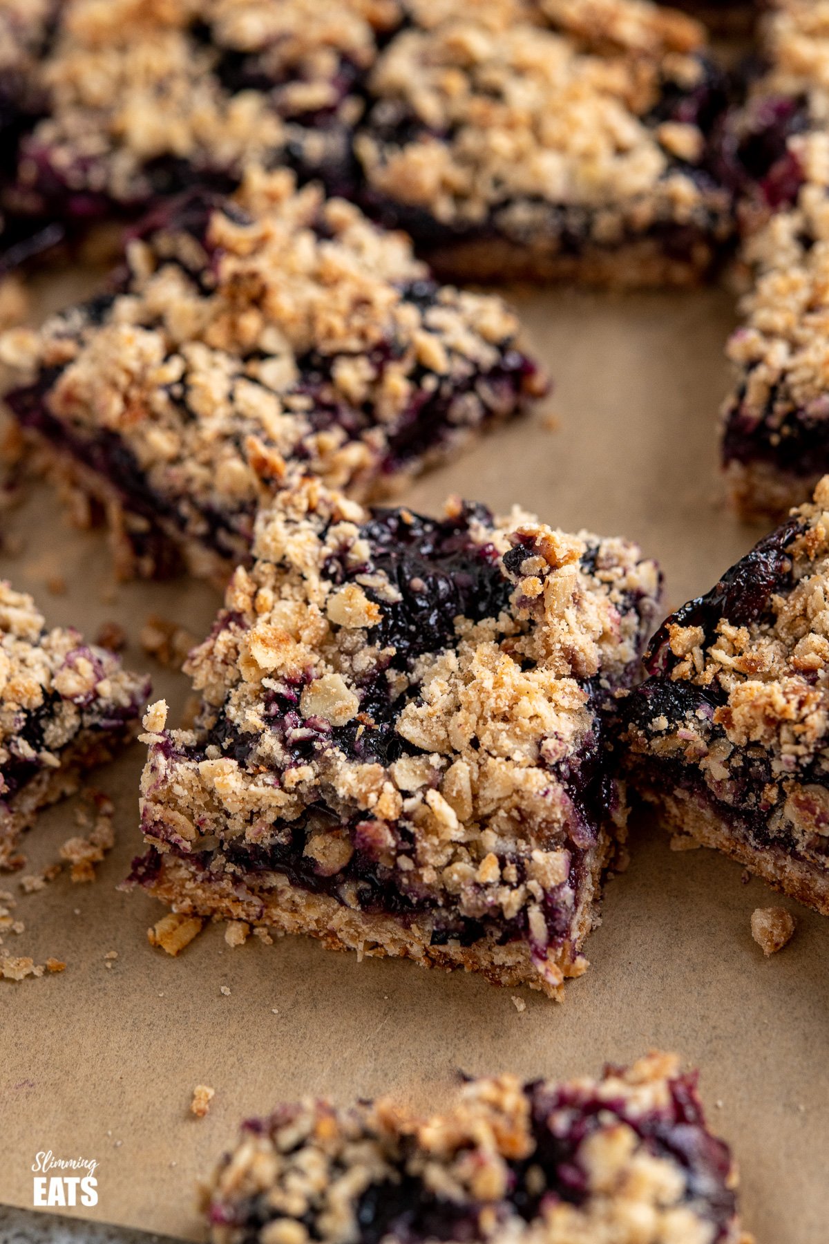 Blueberry Oat Crumble Bars on parchment paper
