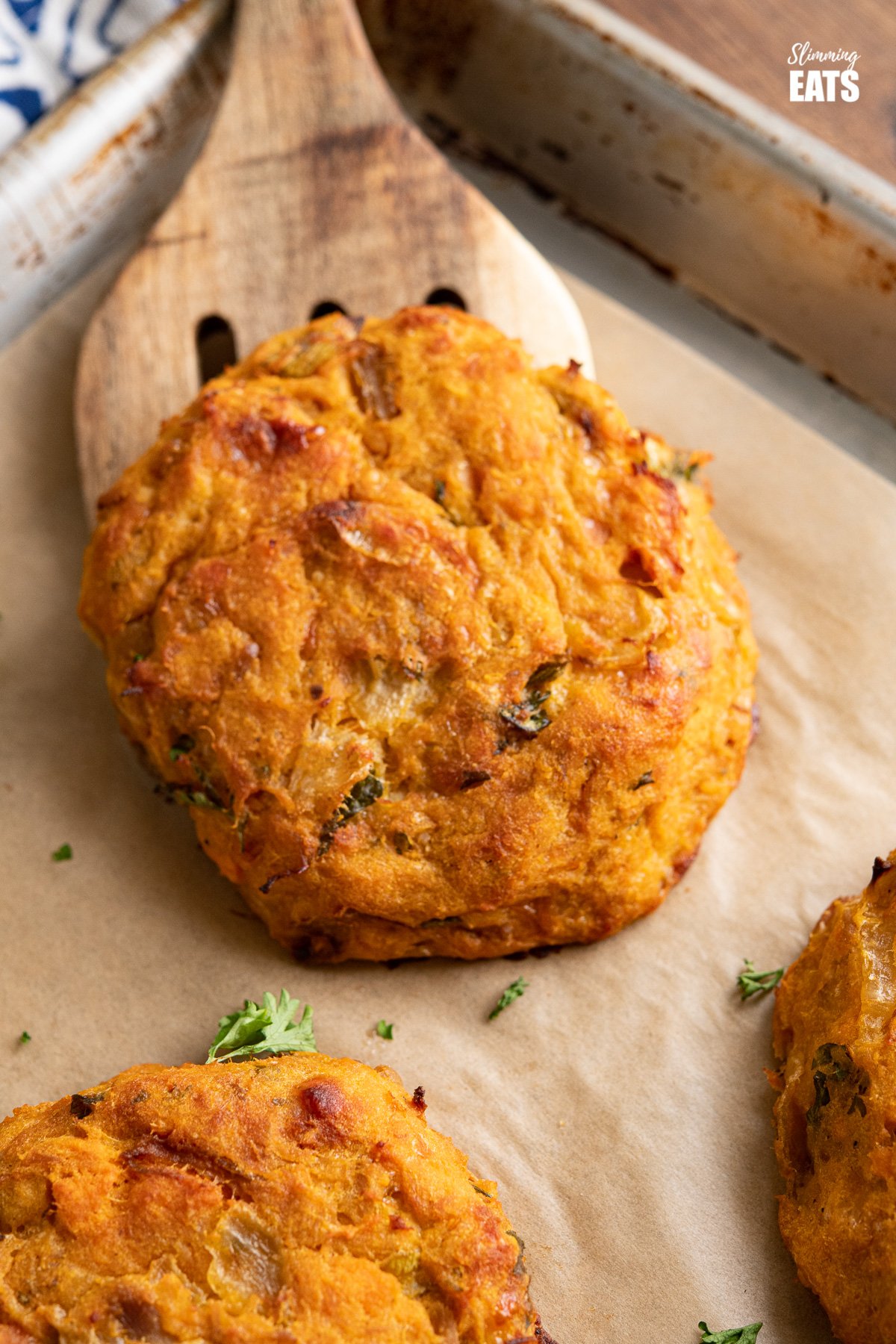 Tuna Sweet Potato Cheddar Patties - make these delicious patties with a few simple ingredients for a tasty lunch at home or on the go. #tuna #sweetpotato #slimmingeats #weightwatchers #glutenfree #cheddar close up of Tuna Sweet Potato Cheddar Patties on parchment lined tray