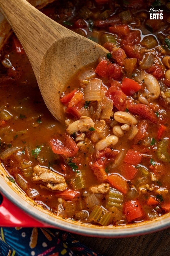 Chicken, Tomato and White Bean Soup - this hearty flavoursome soup is a complete meal in a bowl that the whole family will love. Gluten Free, Slimming World and Weight Watchers friendly chicken, tomato and white bean soup in cerise cast iron pot