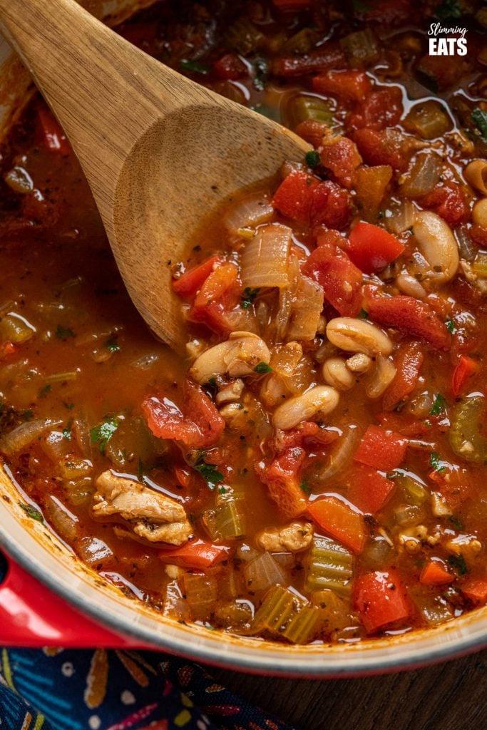 chicken, tomato and white bean soup in cerise cast iron pot