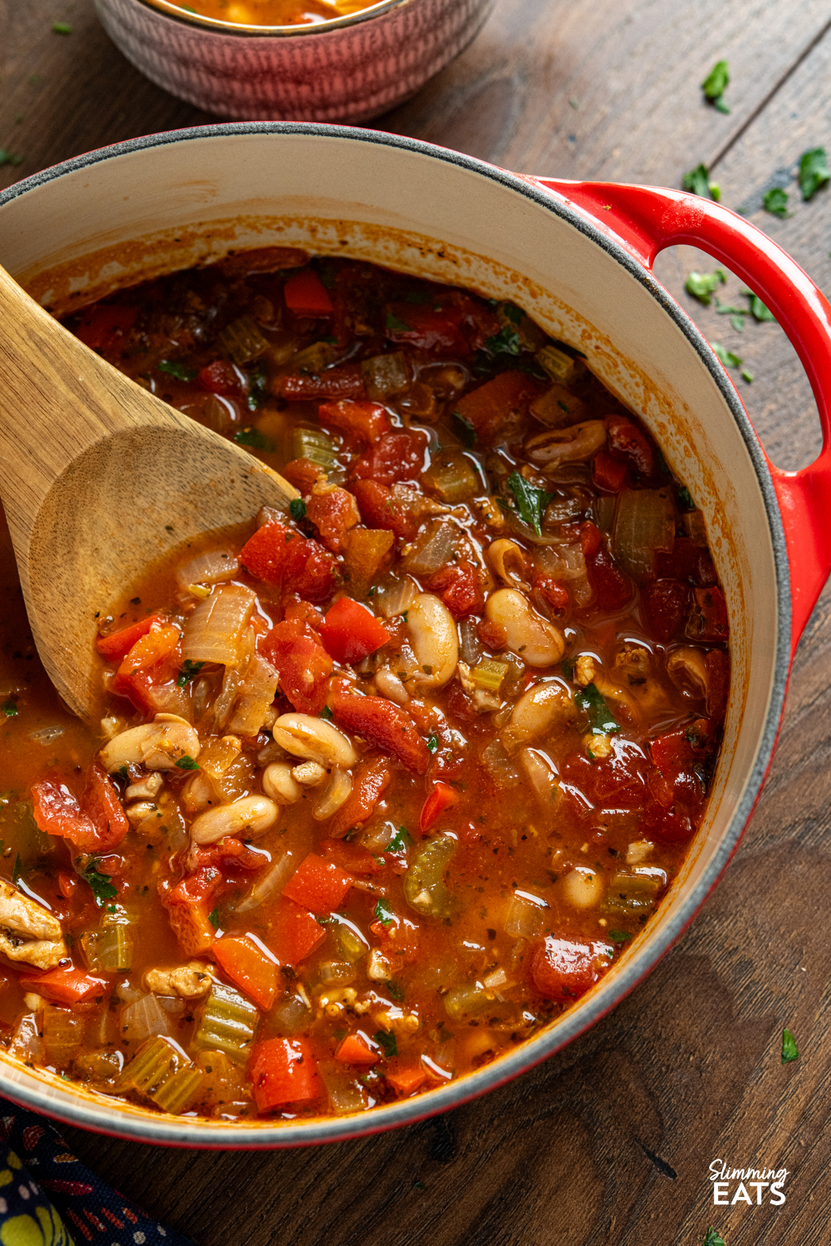 Chicken, Tomato and White Bean Soup - this hearty flavoursome soup is a complete meal in a bowl that the whole family will love. chicken, tomato and white bean soup in cerise cast iron pot