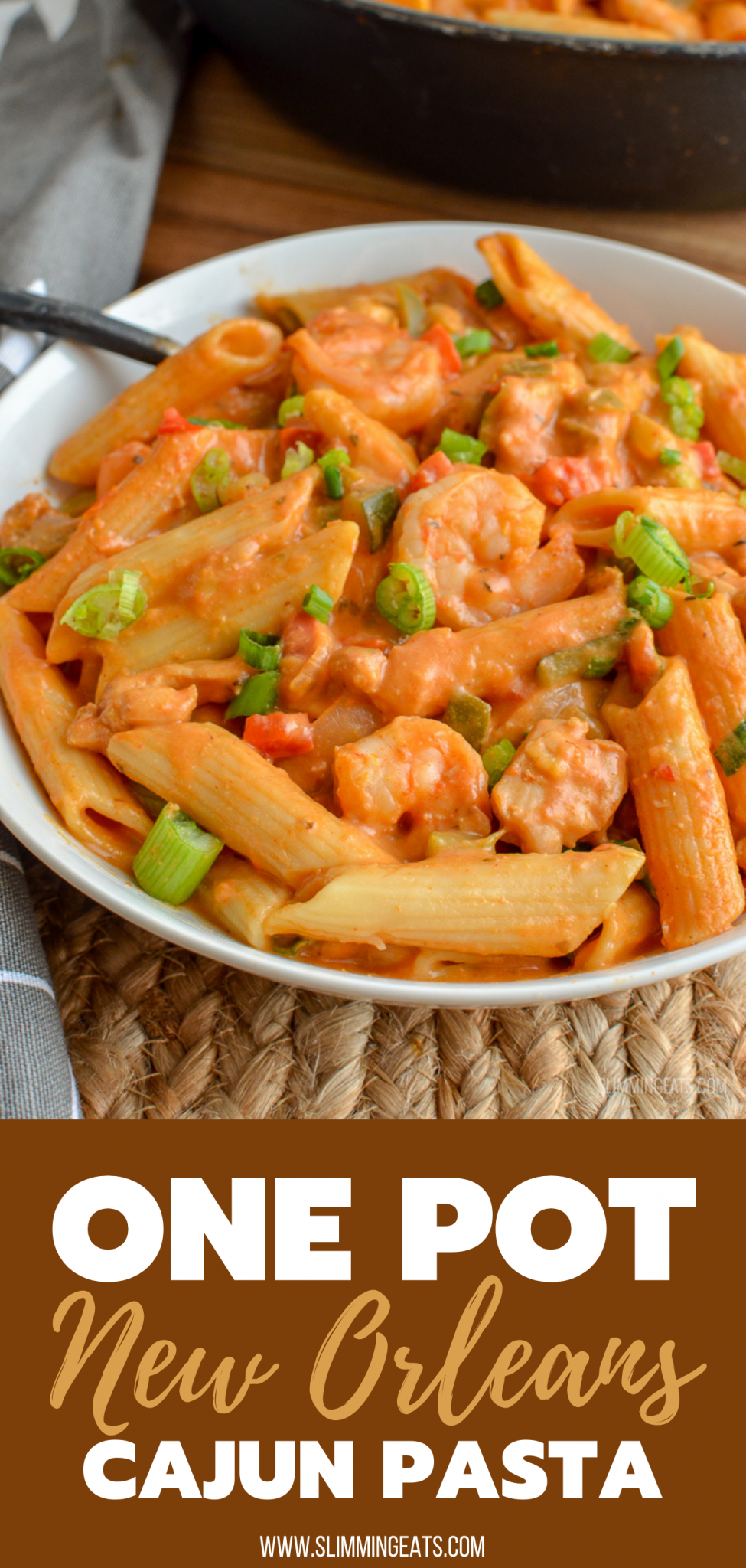 New Orleans Cajun Pasta in white bowl with pasta, shrimp and chicken visible in dish. 