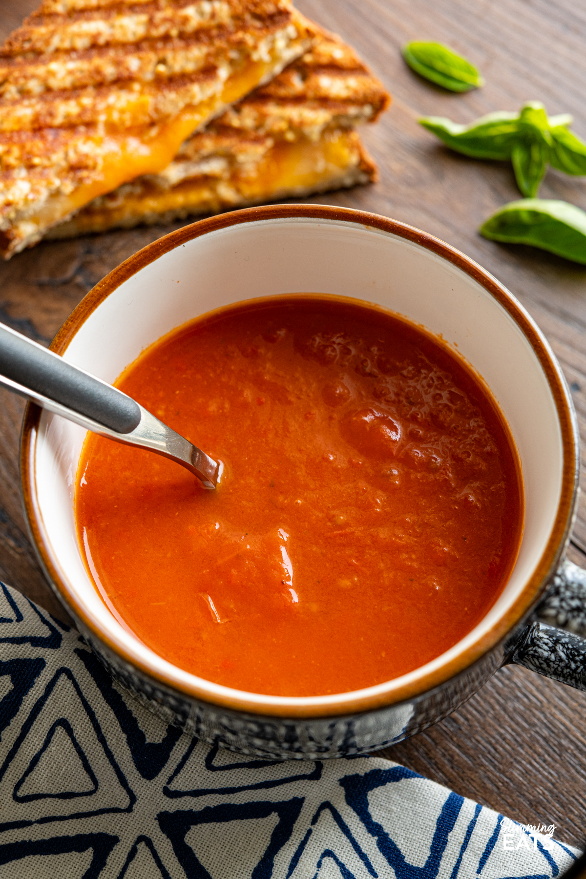 Roasted Red Pepper and Tomato Soup - a simple but delicious soup made with fresh peppers and tomatoes perfect with a grilled cheese sandwich. Gluten Free, Dairy Free, Vegan, Vegetarian, Slimming Eats and Weight Watchers friendly cup of Roasted Red Pepper and Tomato Soup with spoon