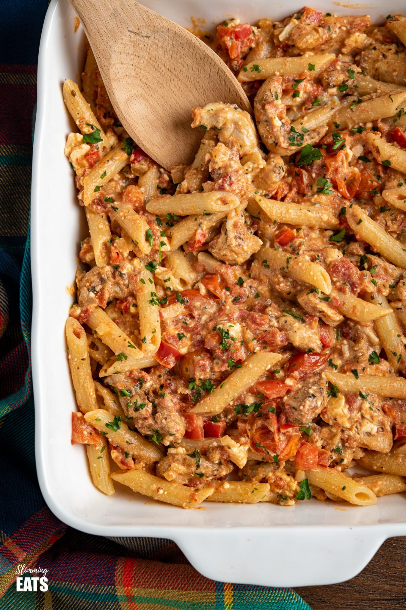 close up of Baked feta pasta in white oven dish with chicken