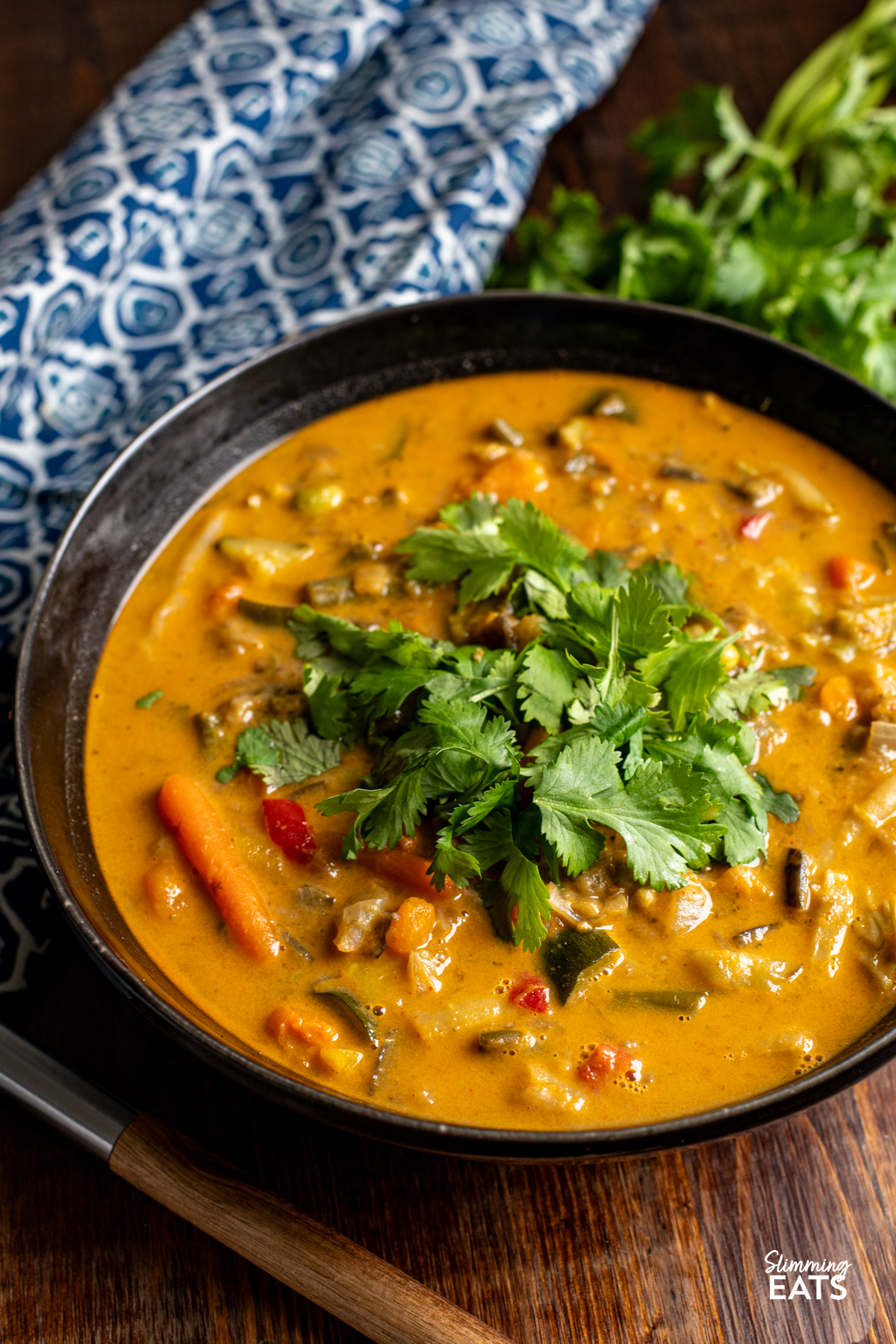 Thai Vegetable Soup in a black bowl topped with coriander