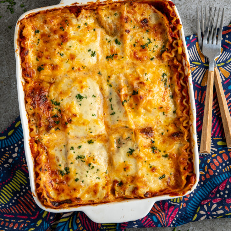 featured image of chicken sweetcorn lasagne with forks place to right of dish