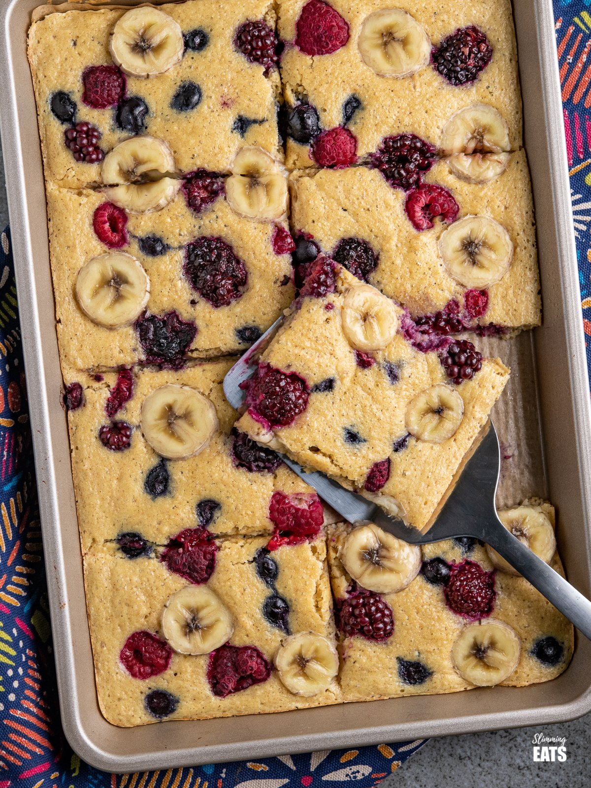 sliced Sheet Pan Oat Pancakes in a baking tray with spatula