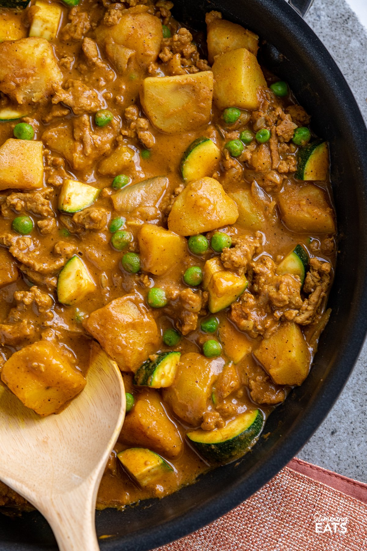 close up of ground turkey and potato curry in black frying pan