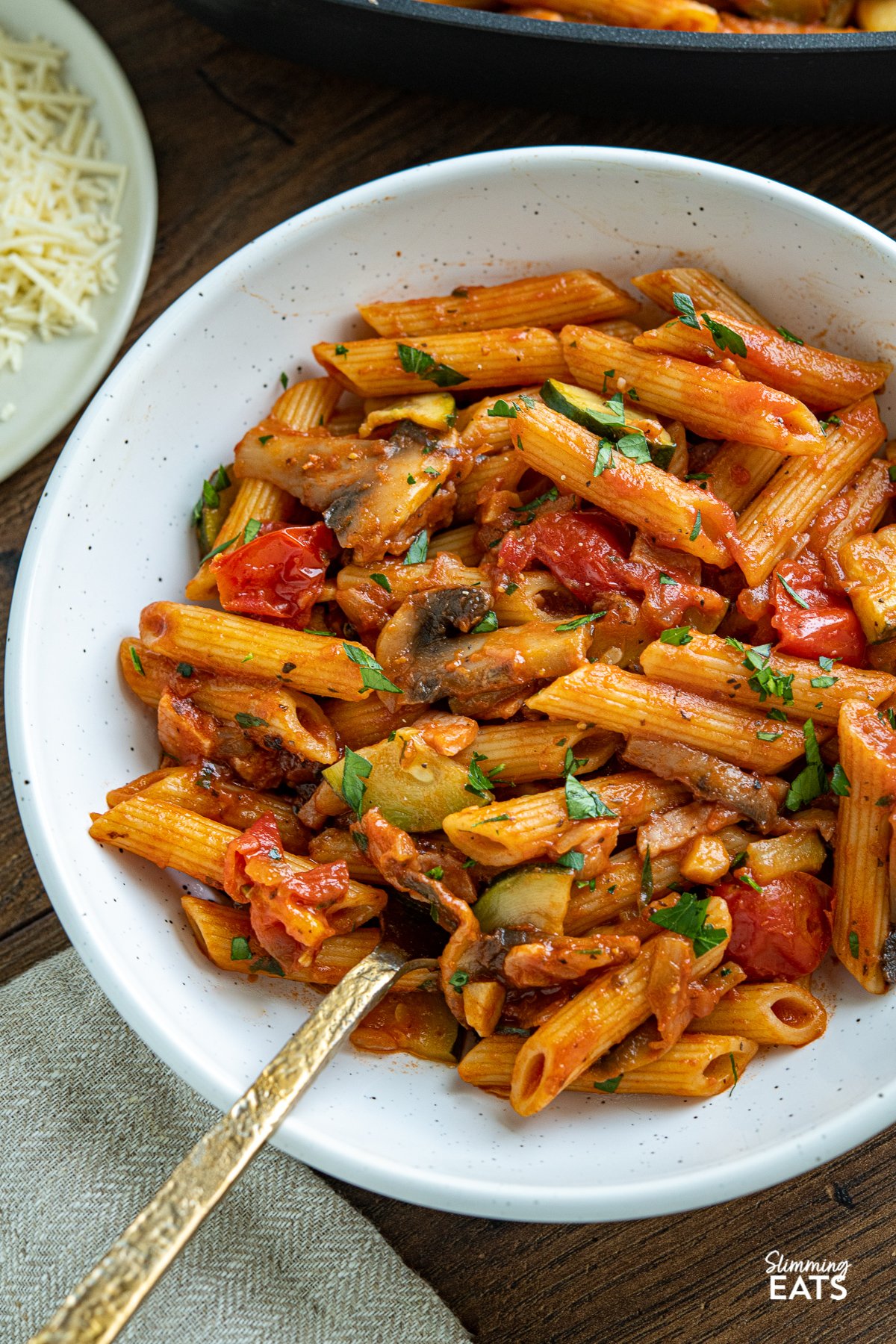 close up of Mushroom, Bacon, Tomato and Zucchini Pasta in white bowl