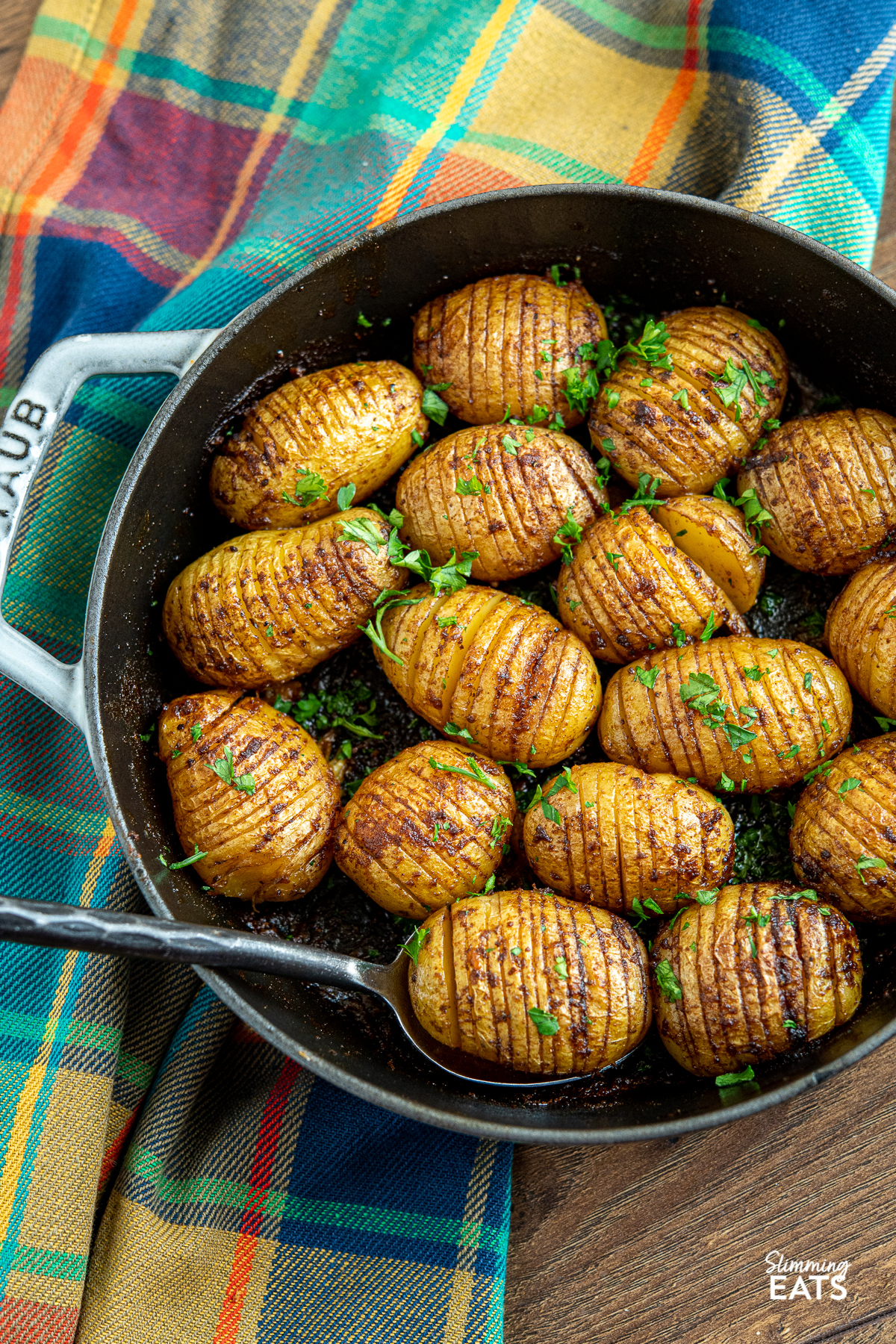 Garlic Hasselback Potatoes in a grey staub cast iron pan