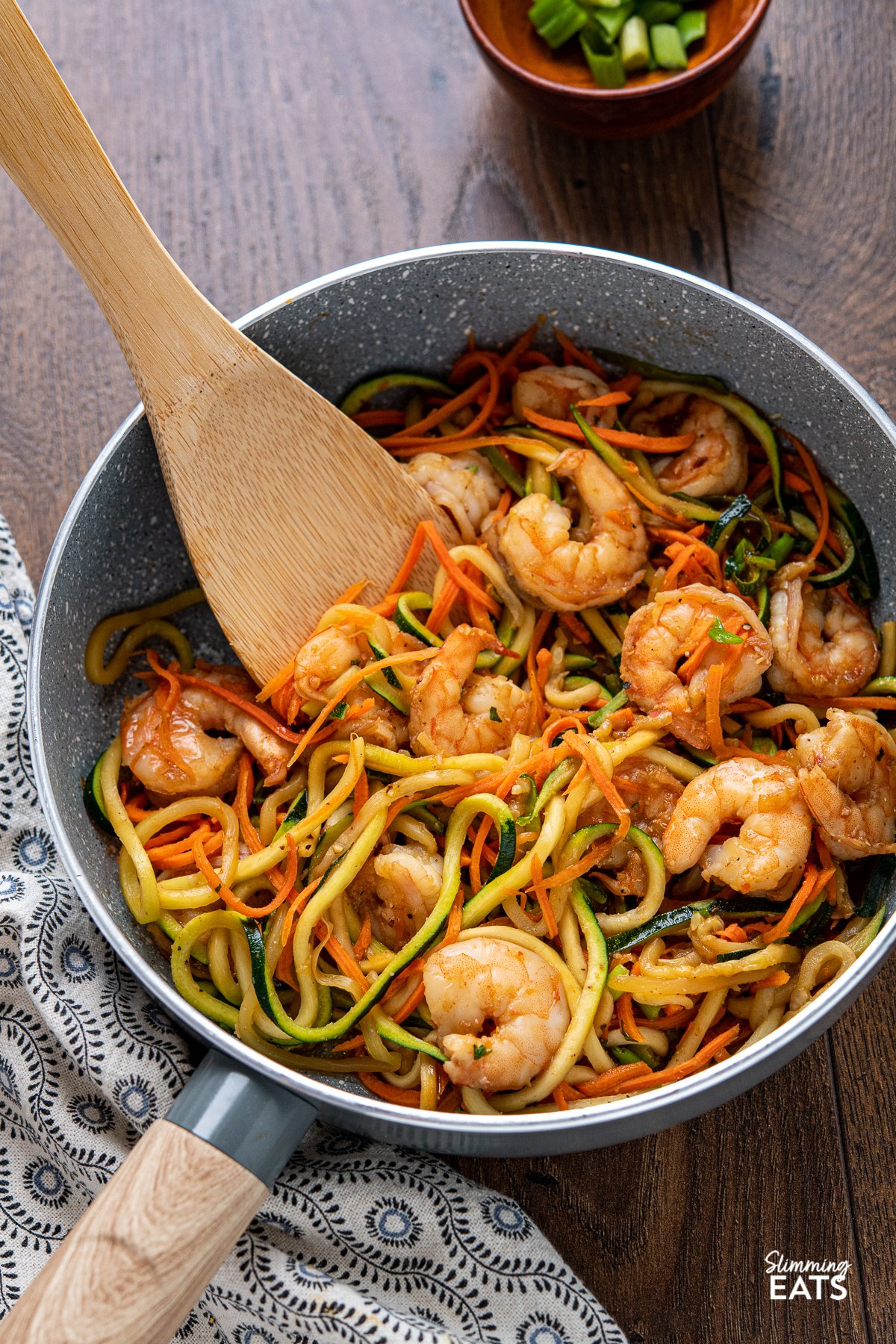 Quick Sweet Chilli Prawns with Vegetable Noodles - a quick and easy stir fry recipe that is lighter on the carbs with some healthy spiralized vegetable noodles. Slimming World and Weight Watchers friendly Quick Sweet Chilli Prawns with Vegetable Noodles in a grey non stick frying pan