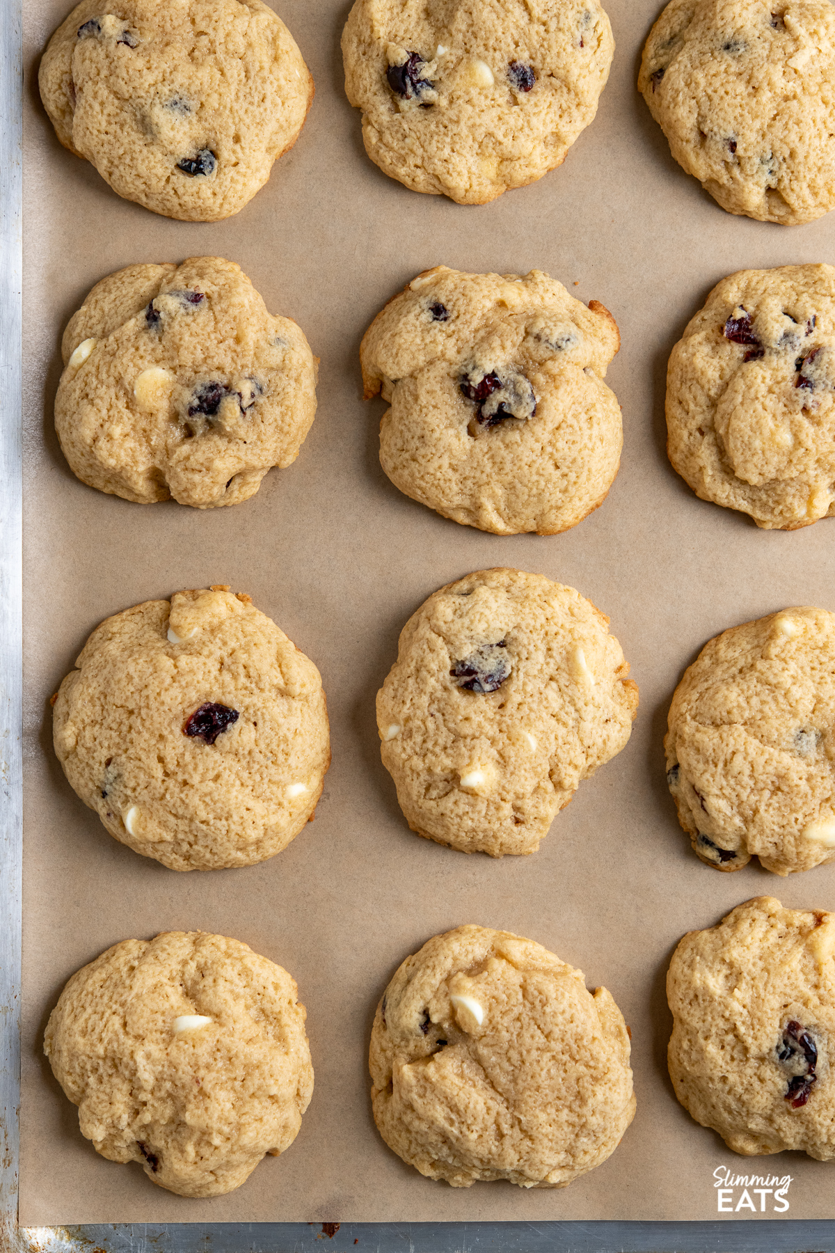 Cranberry White Chocolate Scone Cookies on a parchment lined baking tray