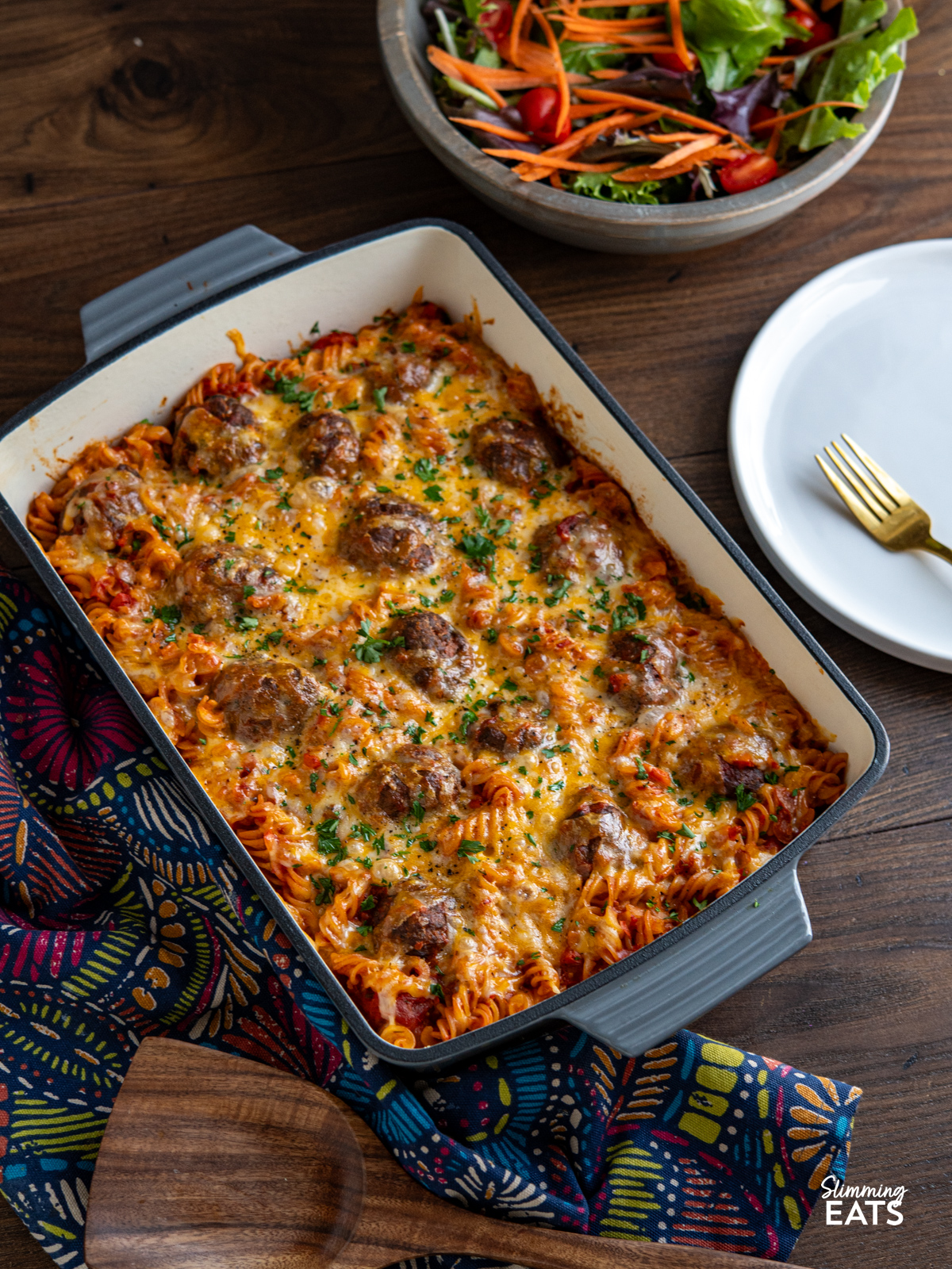 Cheesy Meatball Pasta Bake - delicious and lean homemade beef meatballs in a rich tomato sauce all stirred into fusilli pasta, topped with cheese and baked in the oven until melted and golden for a perfect family meal.