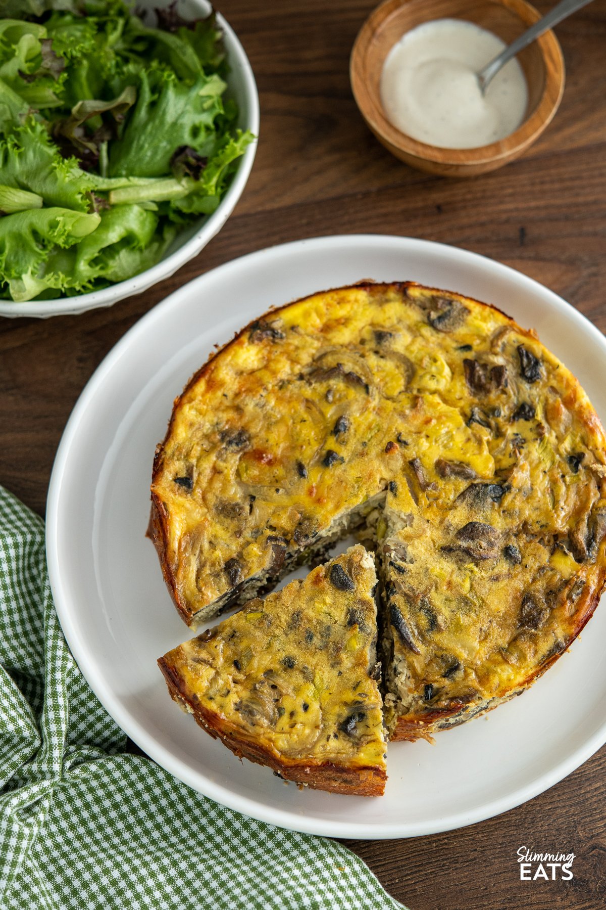 sliced crustless mushroom quiche on white plate