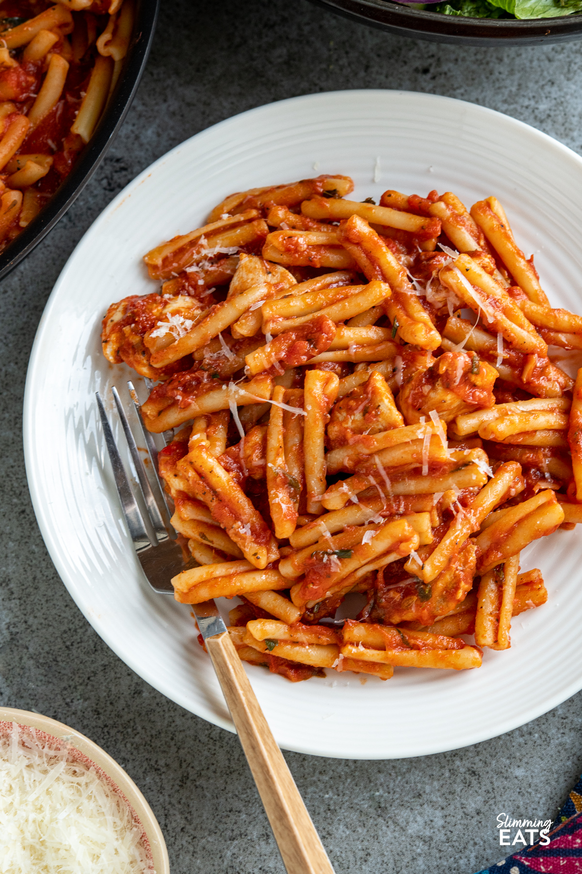 close up of Chicken Arrabbiata Pasta on white plate with fork