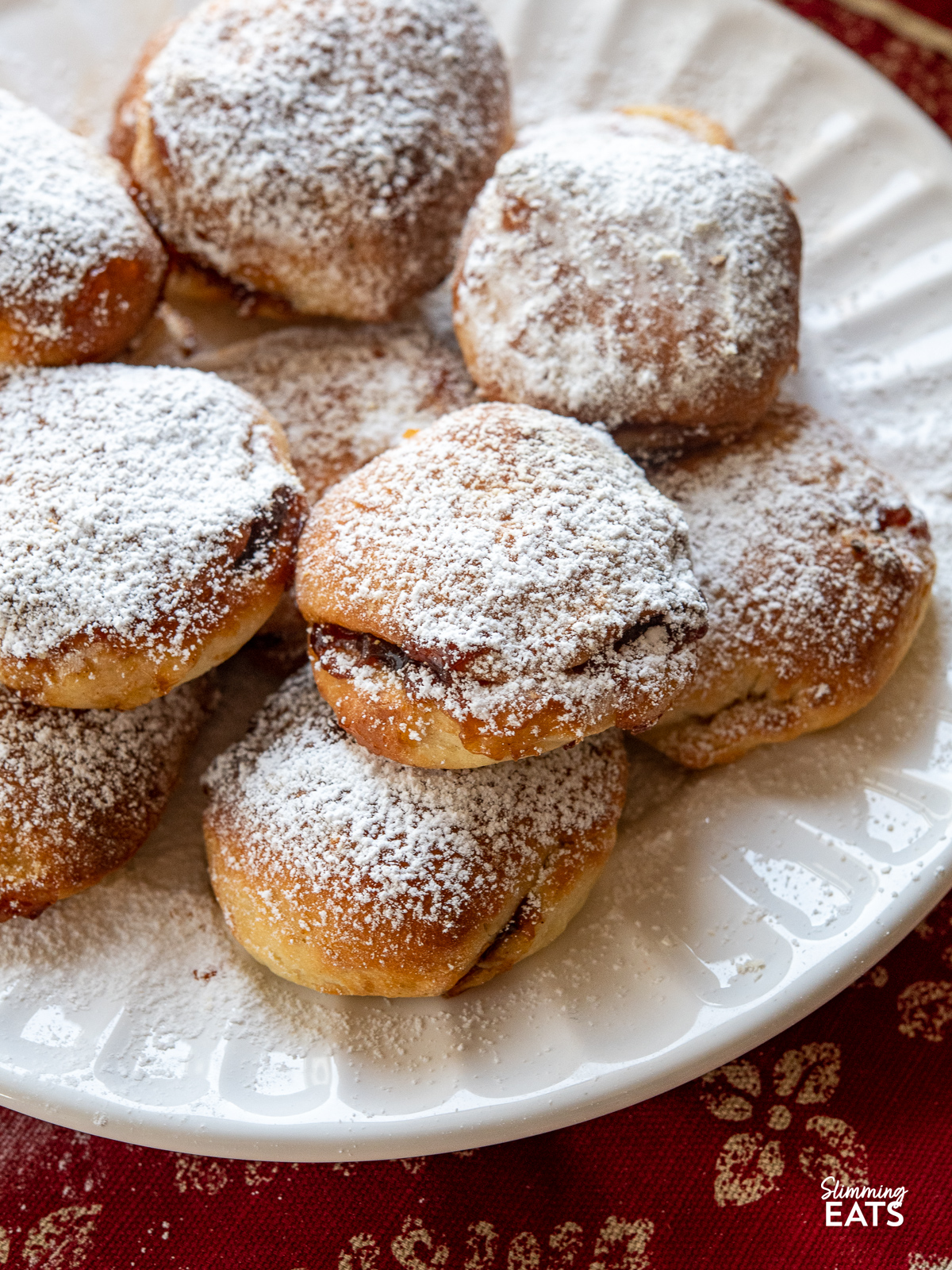 close up of Air Fryer Mince Pie Bites on a white plate dusted with icing sugar