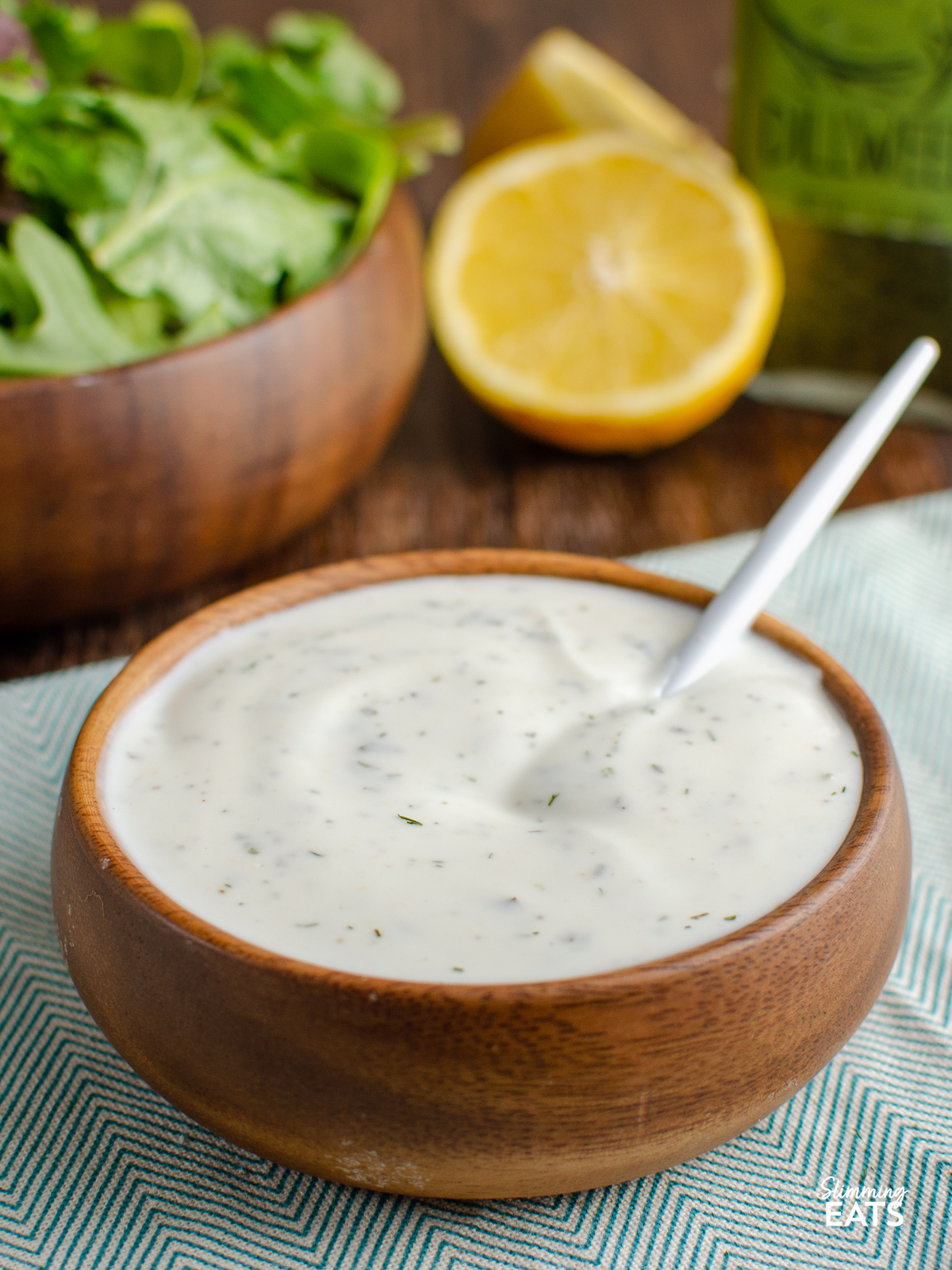 Homemade Light Ranch Yoghurt Dressing in a wooden bowl with spoon