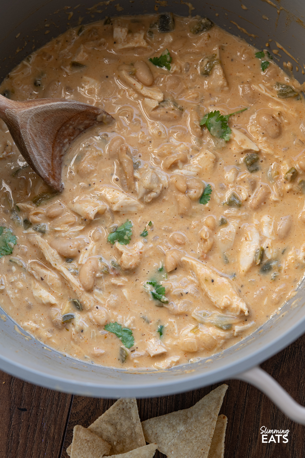 White Chicken Chili in a deep pot with wooden spoon