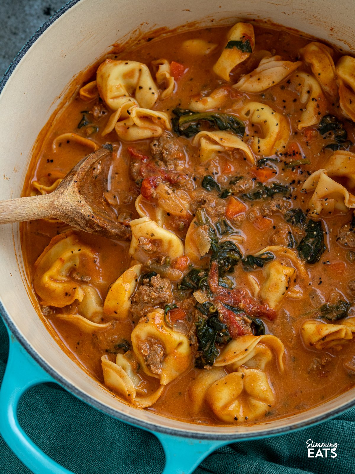 Creamy Italian Sausage Tortellini Soup in teal cast iron le creuset