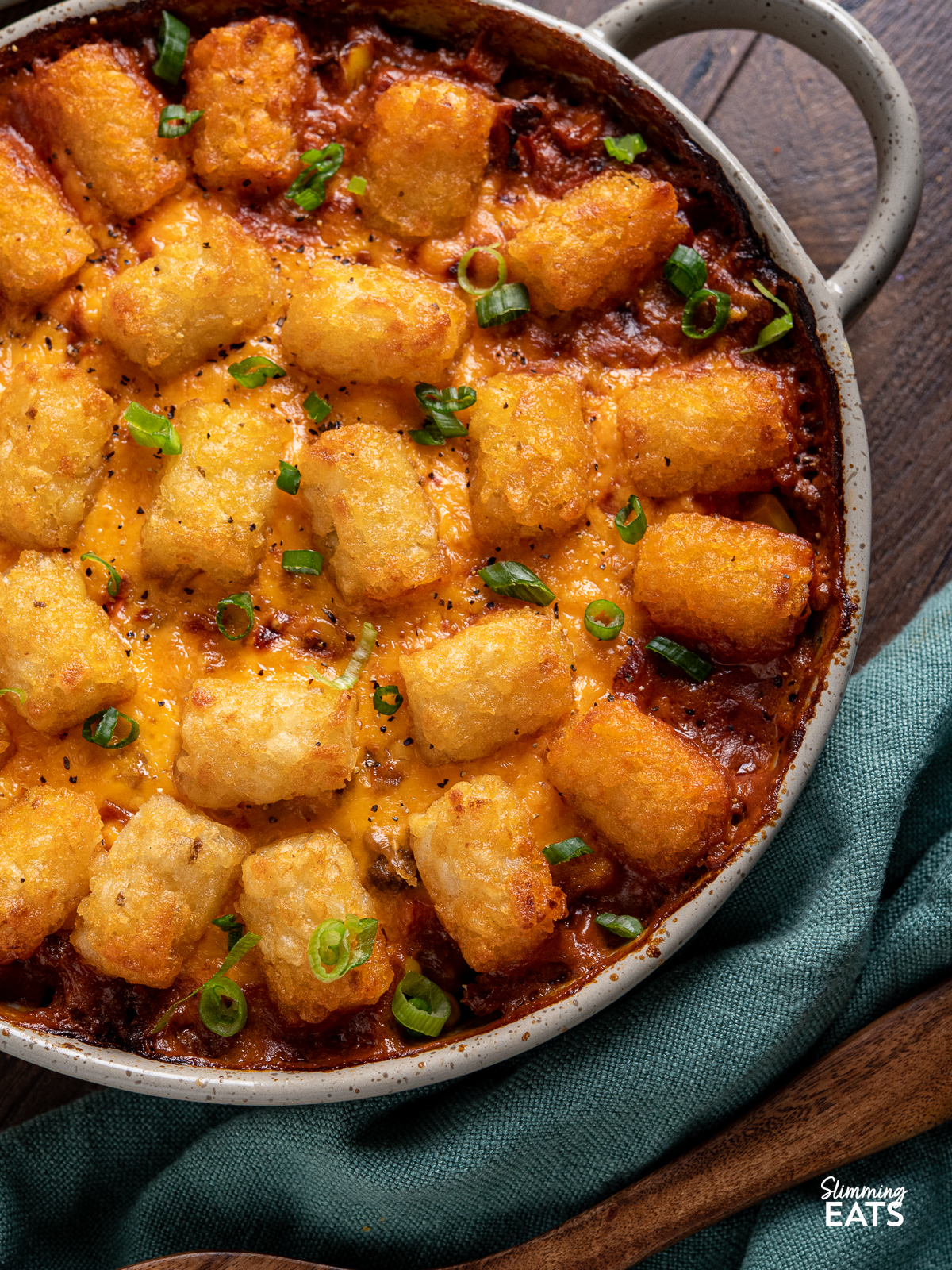Tater Tot Casserole in a round oven dish with two handles