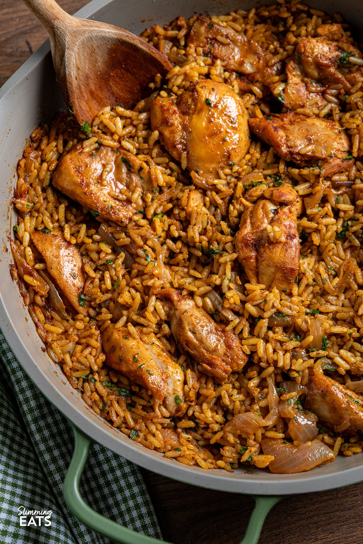 If you're in search of a hassle-free, one-pan recipe bursting with flavour, you're going to adore this One Pot Shawarma Chicken and Rice, featuring an exquisite blend of Middle Eastern spices. close up of chicken shawarma and rice in a green ceramic non stick pan